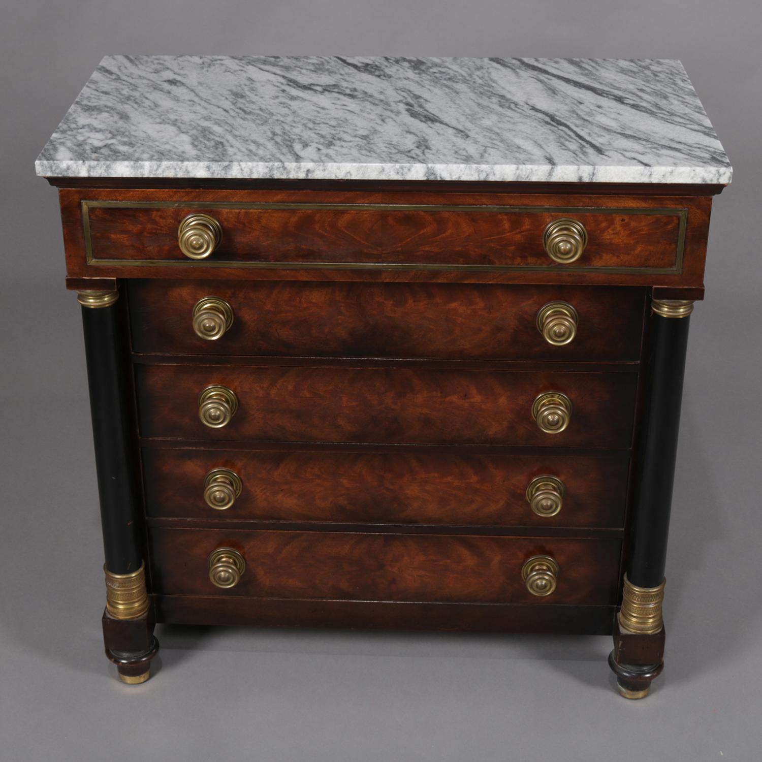 Antique French Empire Charles-Honore Lannuier School Chest features mahogany construction with marble top over upper frieze drawer above four lower long drawers each having bookmatched figured flame mahogany and inset bronze banding and flanked by