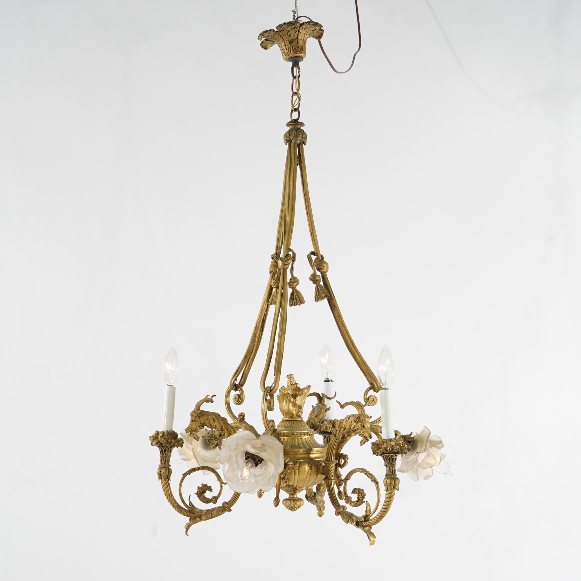 Antique French Empire chandelier offers gilt cast bronze frame in tassel, scroll and foliate form with six arms terminating in candle lights, c1920

Measures - 38