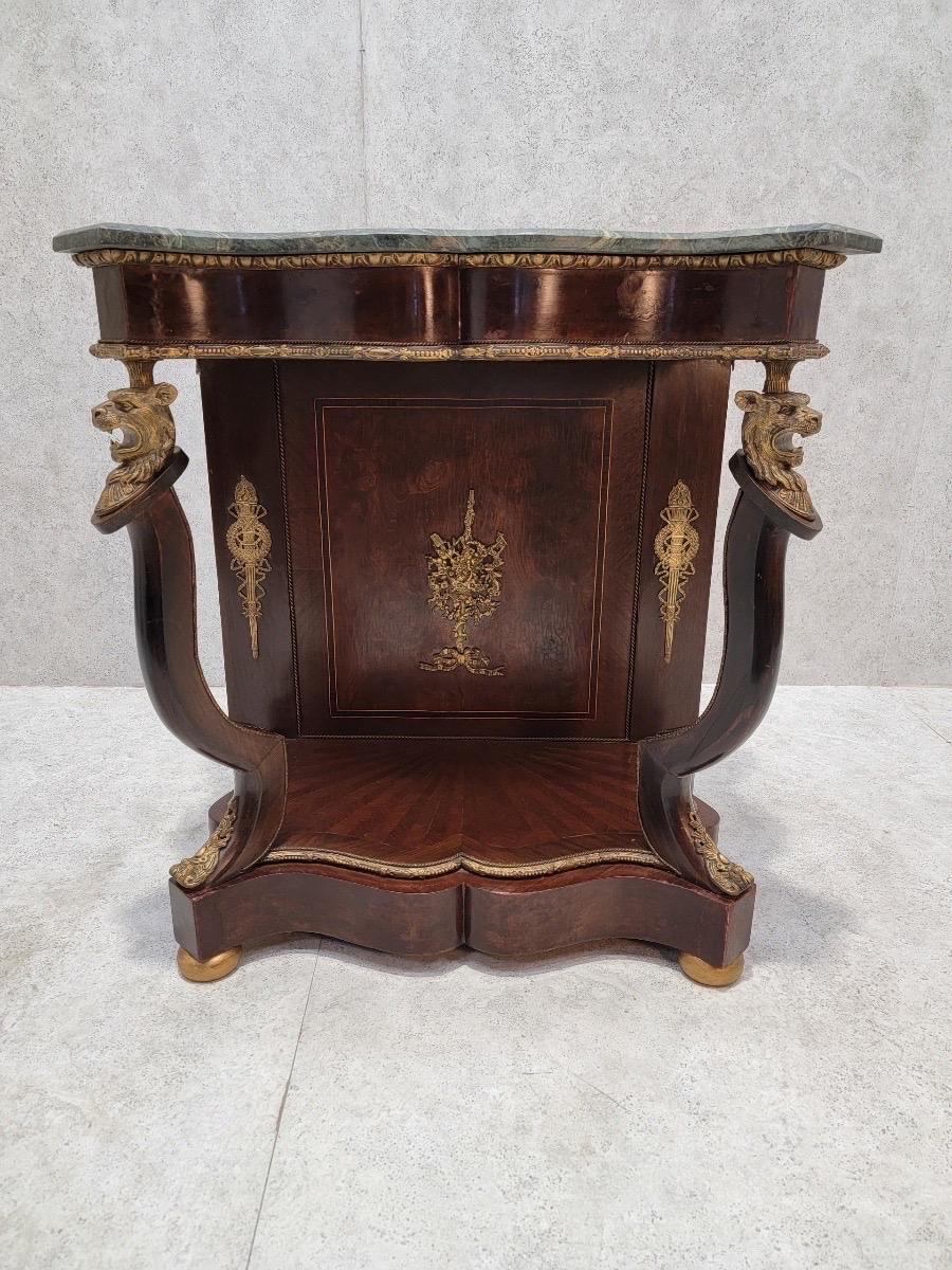 Antique French Empire Lion's Head Ormolu Serpentine Console Table with Italian Marble Top

This stunning French Empire console table is a true masterpiece of art and craftsmanship. Featuring a serpentine-shaped base adorned with intricate brass