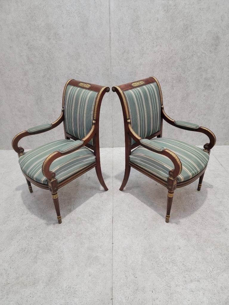 Antique French Empire Mahogany and Gilt Bronze Mounted Armchair in Blue Patterned Stripped Silk Blent - Pair 

This Antique French Empire armchair set is crafted from rich mahogany wood and adorned with intricate gilded bronze mounts, showcasing the