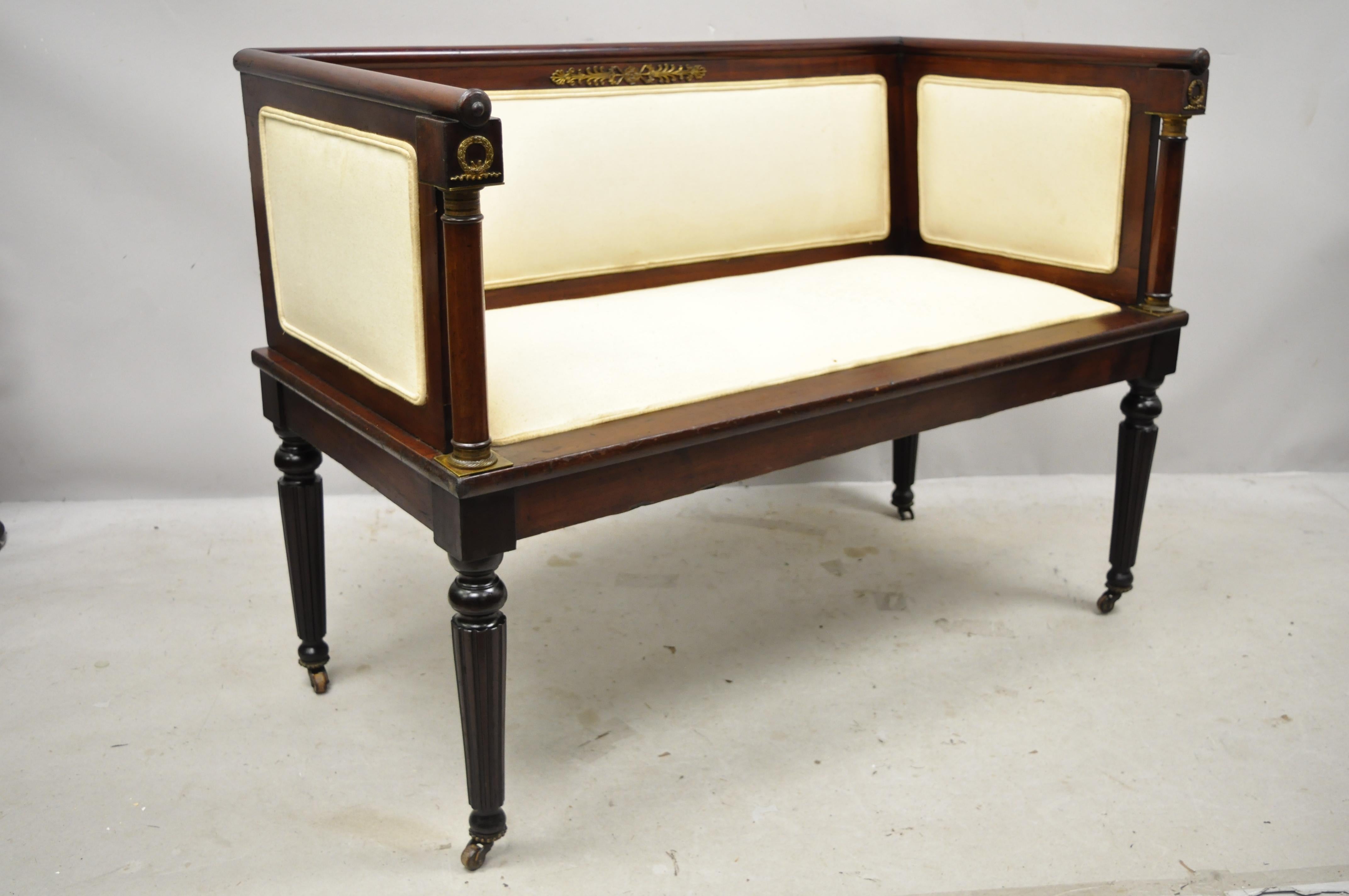 Antique French Empire mahogany bench settee with bronze ormolu and even arms. Item features finely cast bronze ormolu, brass rolling casters, tapered legs, very nice antique item, great style and form, circa early 1900s. Measurements: 32