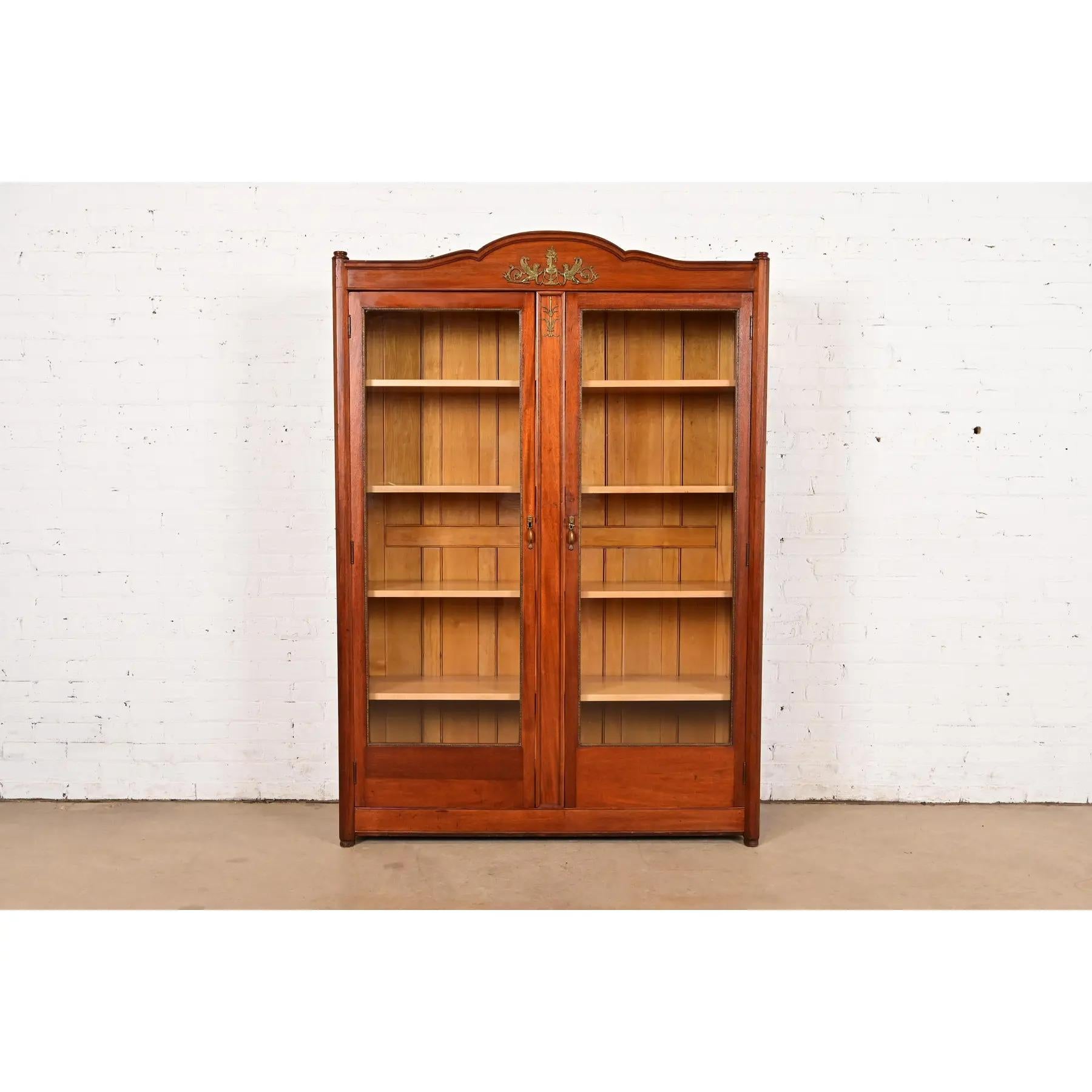 A beautiful antique French Empire bookcase or display cabinet

In the manner of Herter Brothers

USA, Circa 1890s

Carved mahogany, with glass front doors, and mounted gilt bronze ormolu and hardware. 

Measures: 48.63