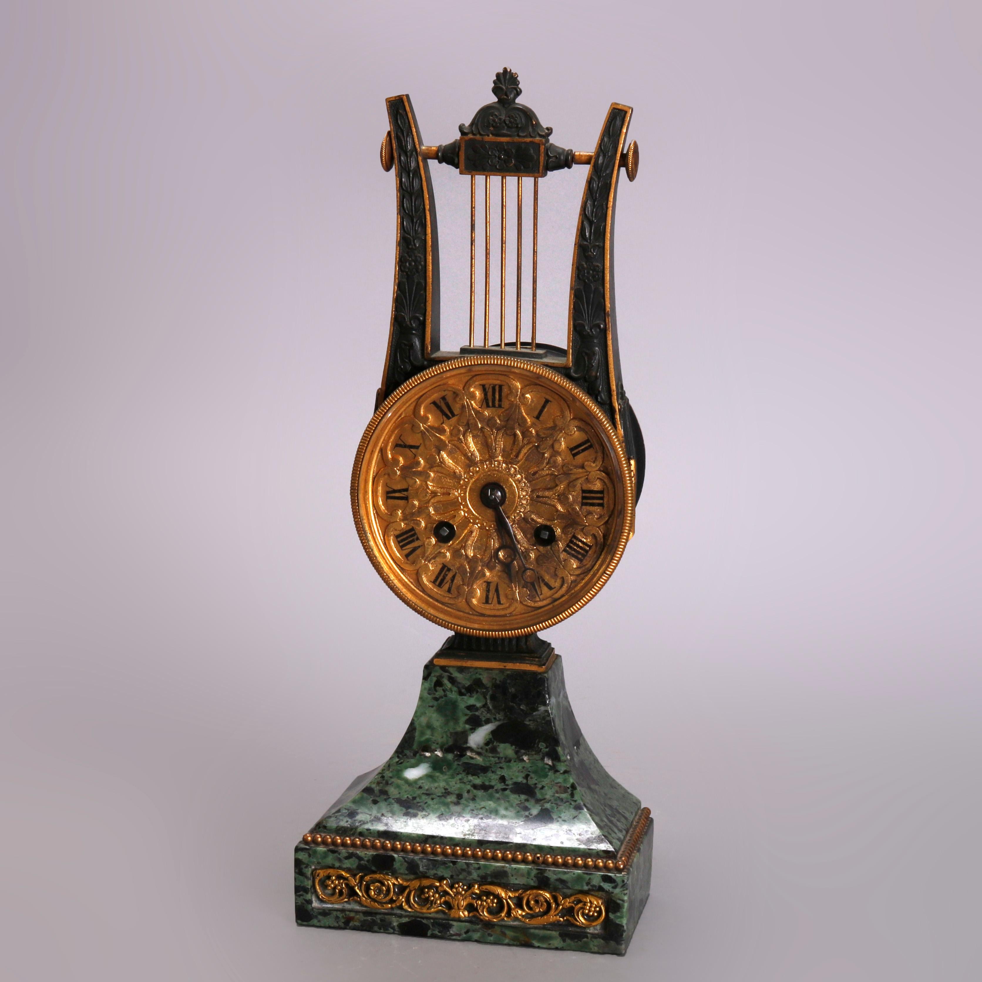 An antique French Empire mantel clock offers marble frame in lyre form with ormolu scroll and foliate mounts, circa 1820

Measures: 11.5