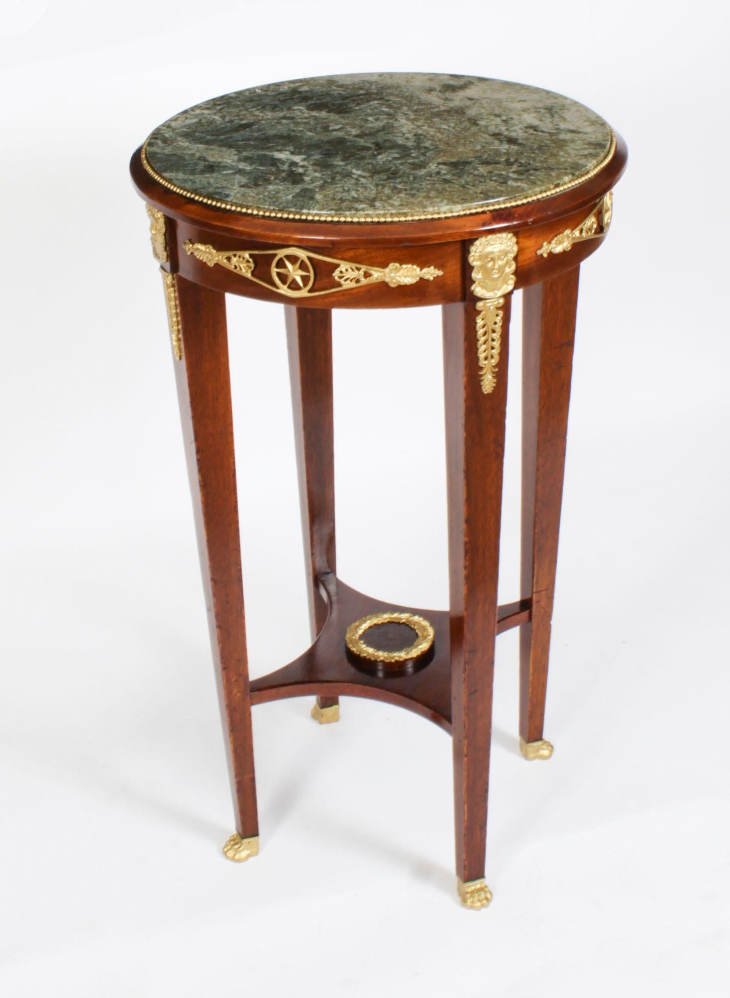 This is a beautiful antique French Empire circular occasional table with ornate ormolu decoration typical of the Empire period and a beautiful inset Verde Antico green marble top, circa 1860.

It is masterfully crafted in a deep rich mahogany with