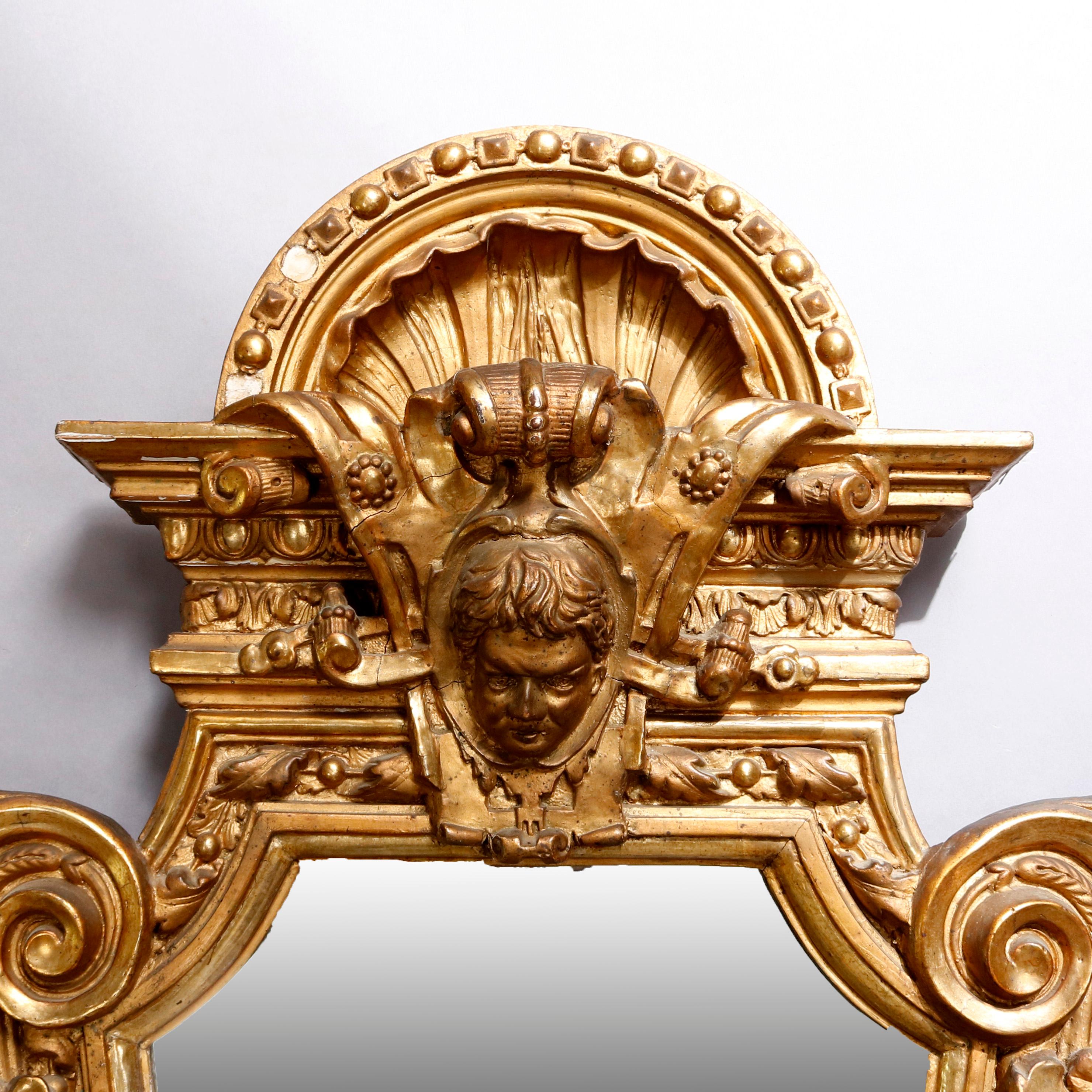 An antique French Empire Napoleon III figural giltwood wall mirror offers shield form with central mask at crest flanked by foliate and scroll decoration and terminating in scrolled foliate apron, circa 1880


Measures: 45