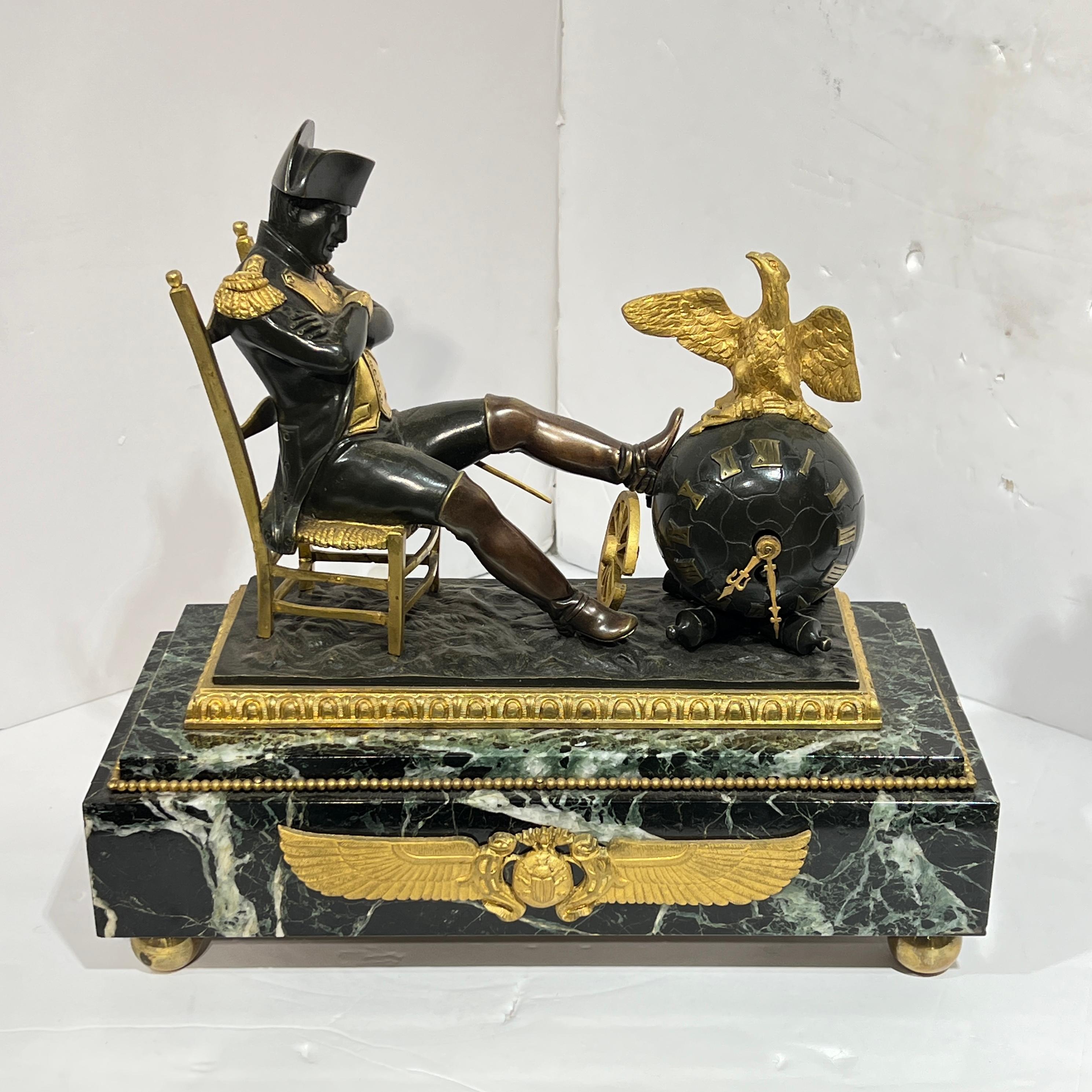 Antique (late 19th century) French garniture in the Empire style including pair of four-light candelabra and mantel clock depicting a seated figure of Napoleon.  Clock 11 inches tall and the candelabra each 16 inches tall.
