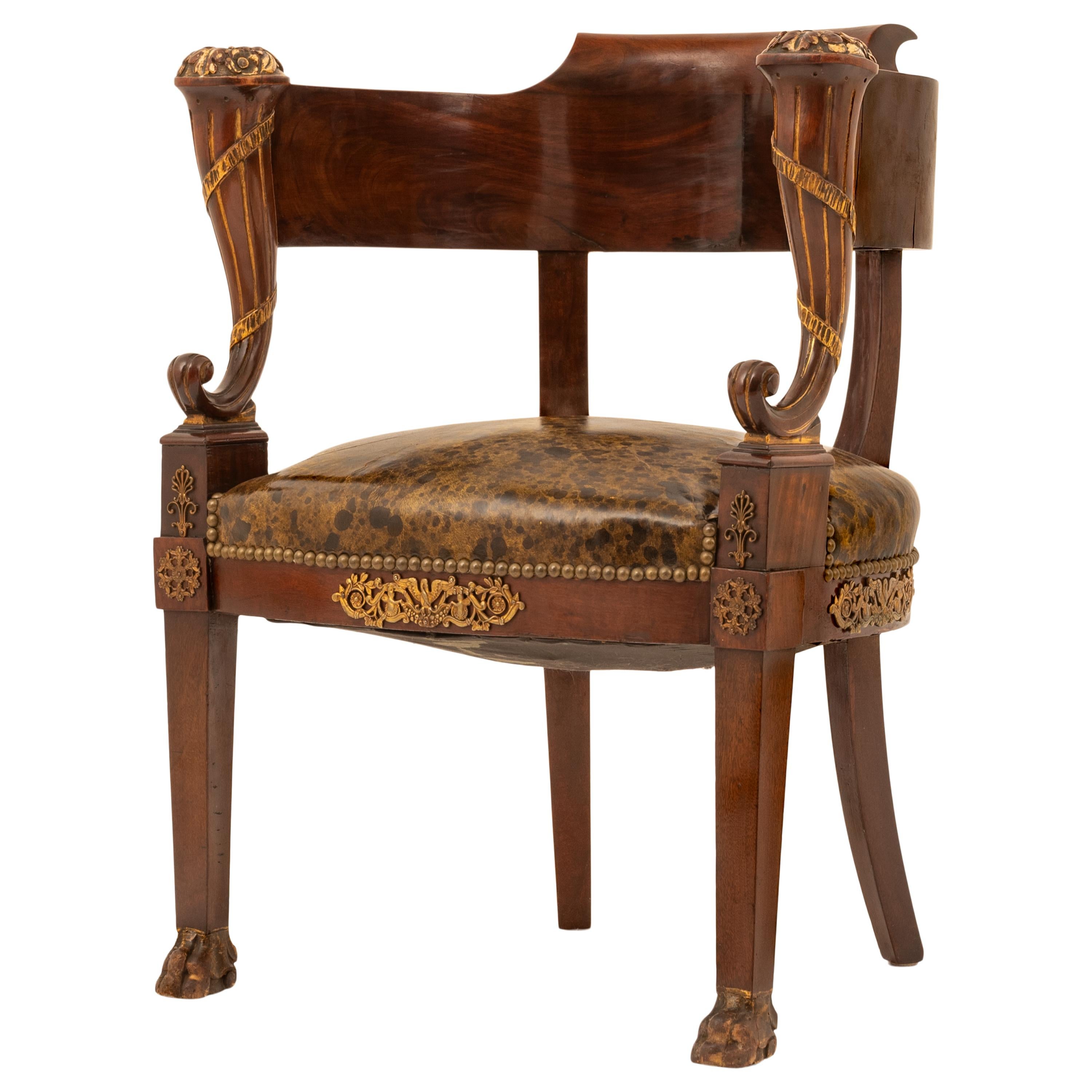 A fine & stylish antique French Empire Napoleonic parcel gilt and ormolu mounted French Fauteuil de bureau (desk chair), circa 1815.
The chair back and armrest of hooped shaped form, with a pair of parcel-gilt cornucopia supports, the leather seat