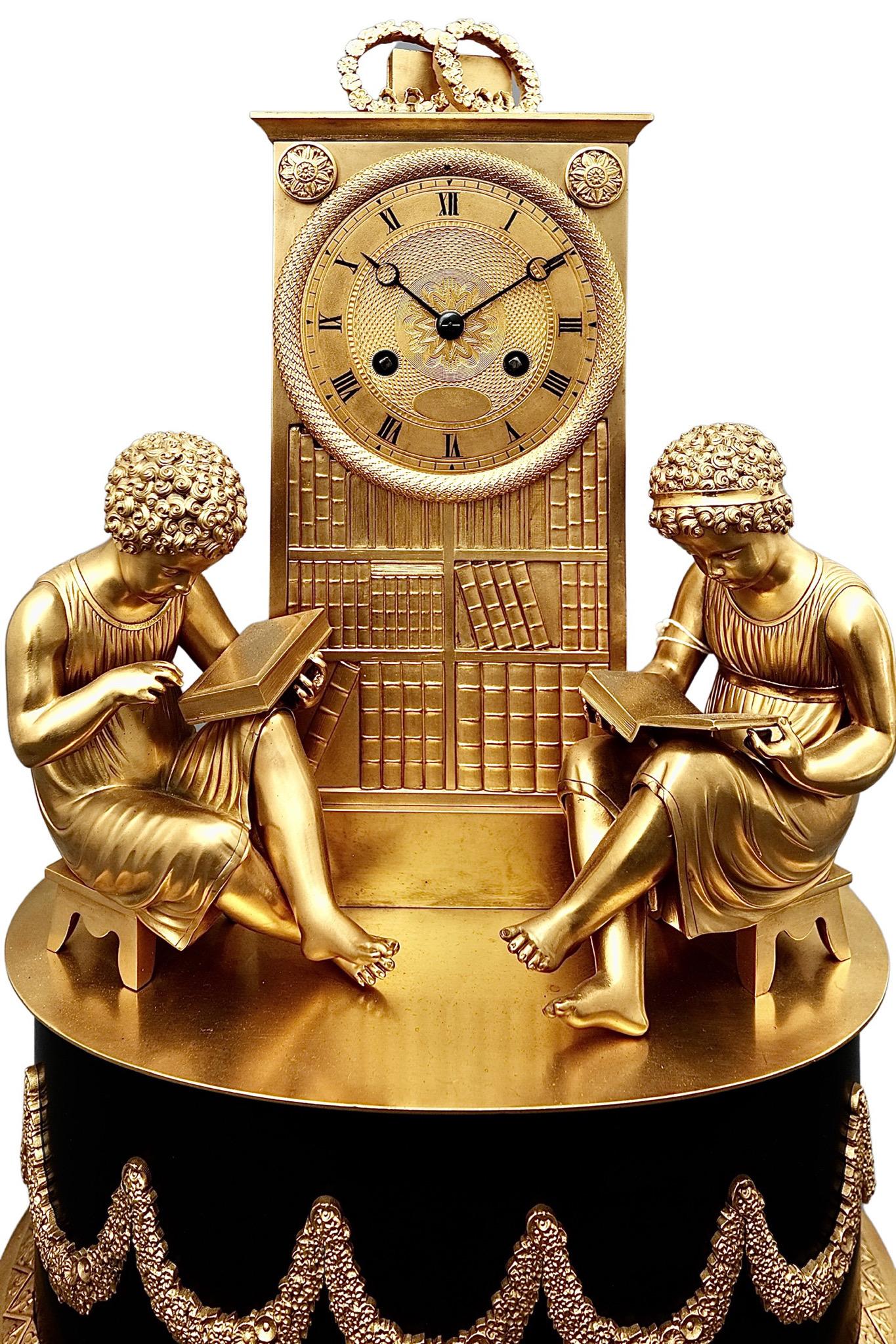 A fascinating Antique French Empire Striking Ormolu mantel clock

A fascinating clock in the form of a library bookcase, with two children sitting at each side. Raised on a plinth on ormolu feet, the Roman dial is cast ormolu with blued steel