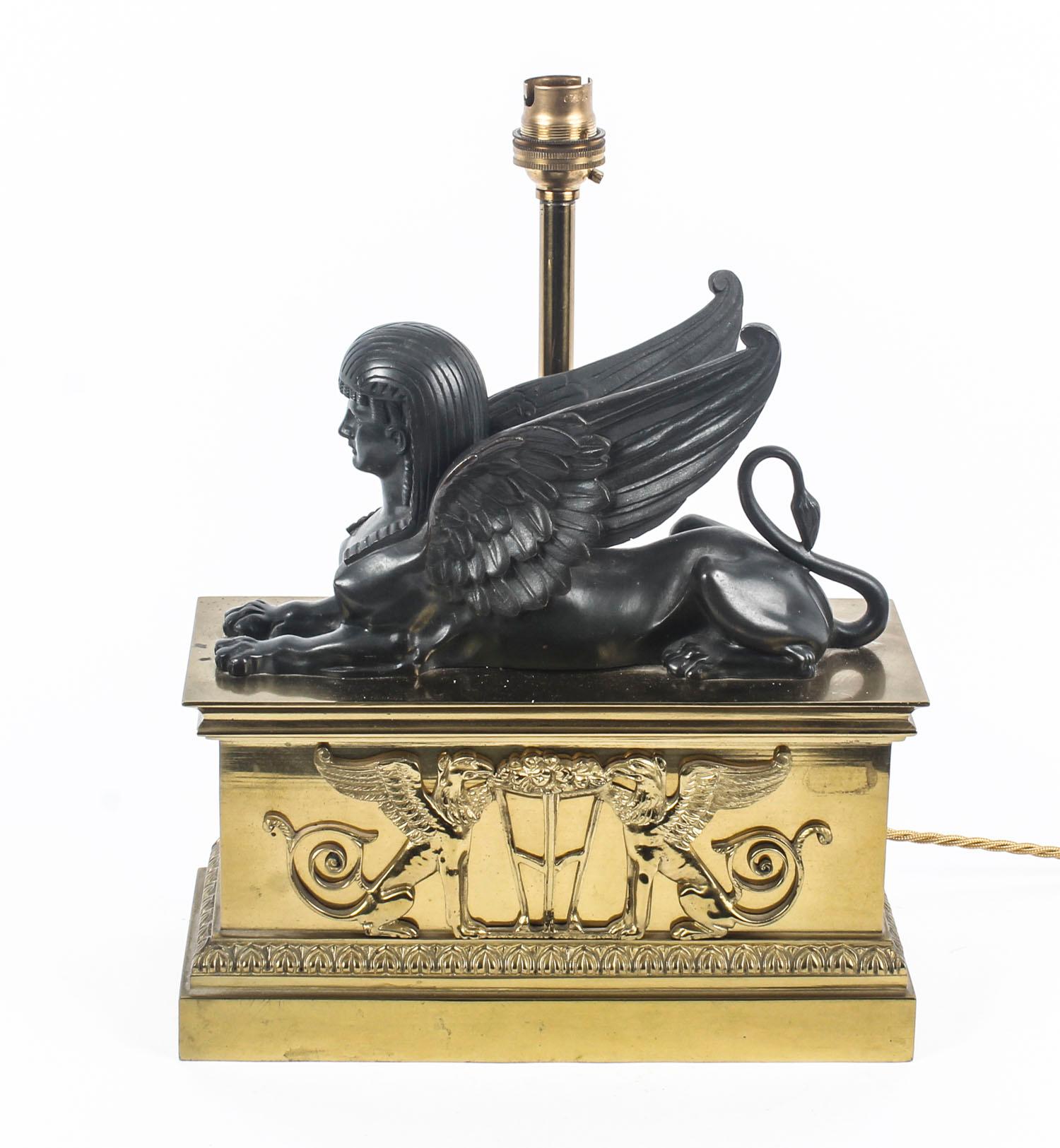 This is a truly superb antique French Empire period Egyptian Revival patinated bronze modeled as a recumbent winged sphinx mounted to an ormolu plinth with applied decoration of griffins flanking a cendrier, circa 1820 in date.

Later converted to