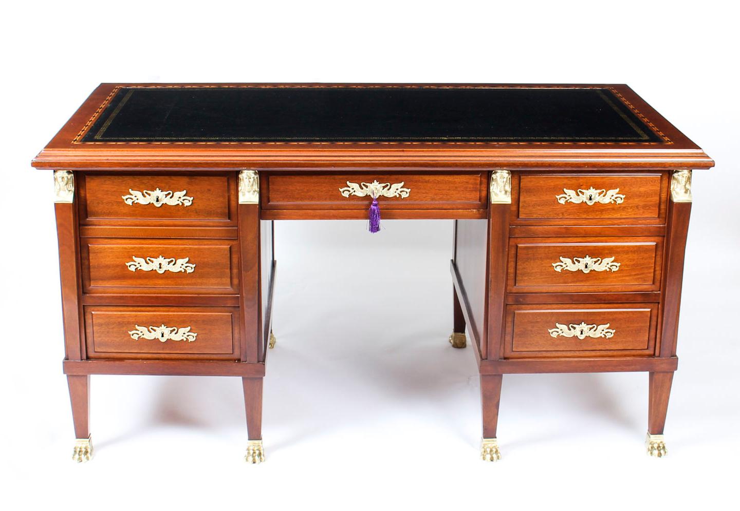 This is an exquisite French Empire Revival pedestal desk, circa 1880 in date.

This desk has been beautifully crafted from flame mahogany. The top has a striking gold tooled black leather inset writing surface which has a decorative geometric inlaid