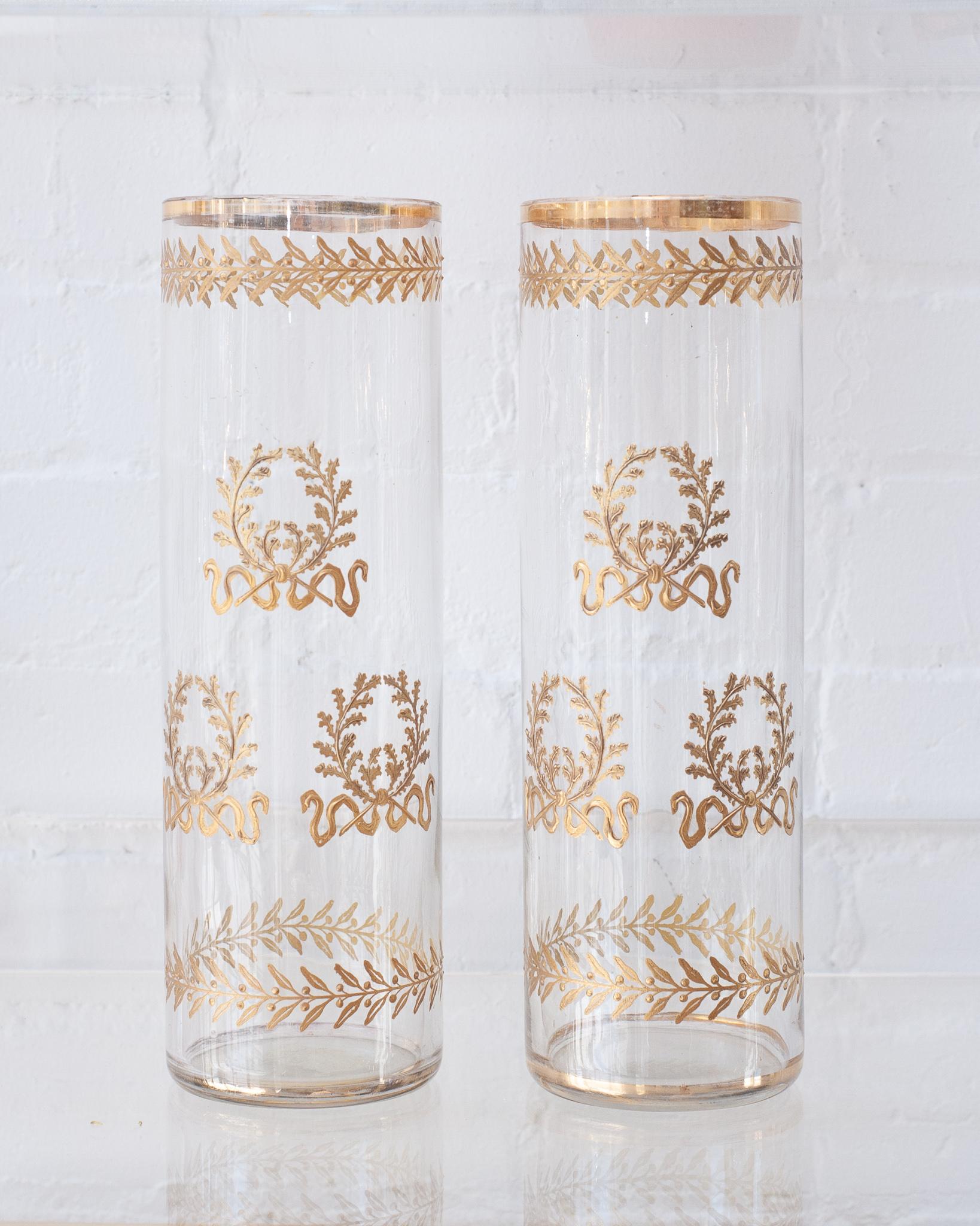 A gorgeous pair of Empire period French antique straight crystal vases. Delicately gilded with gold ormolu wreaths, these timelessly elegant vases are waiting to be filled with fresh flowers.