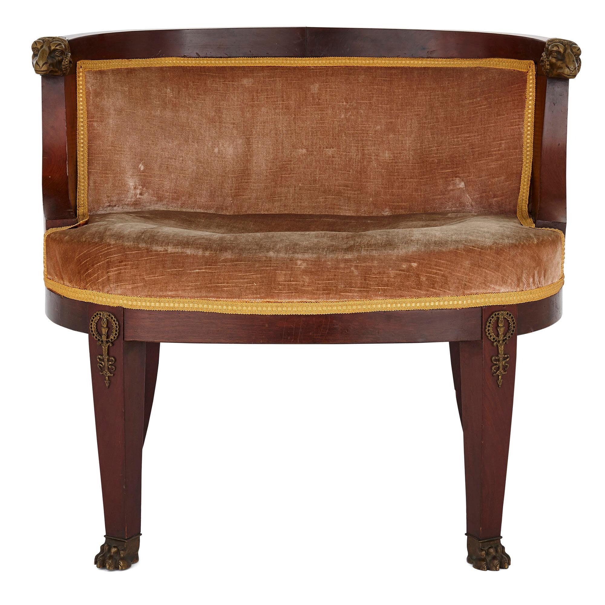 Antique French Empire style armchair
French, early 20th century
Height 65cm, width 74cm, depth 55cm

This elegant armchair is crafted from hardwood, gilt bronze, and upholstery in the Empire style. The chair features an oblong upholstered seat