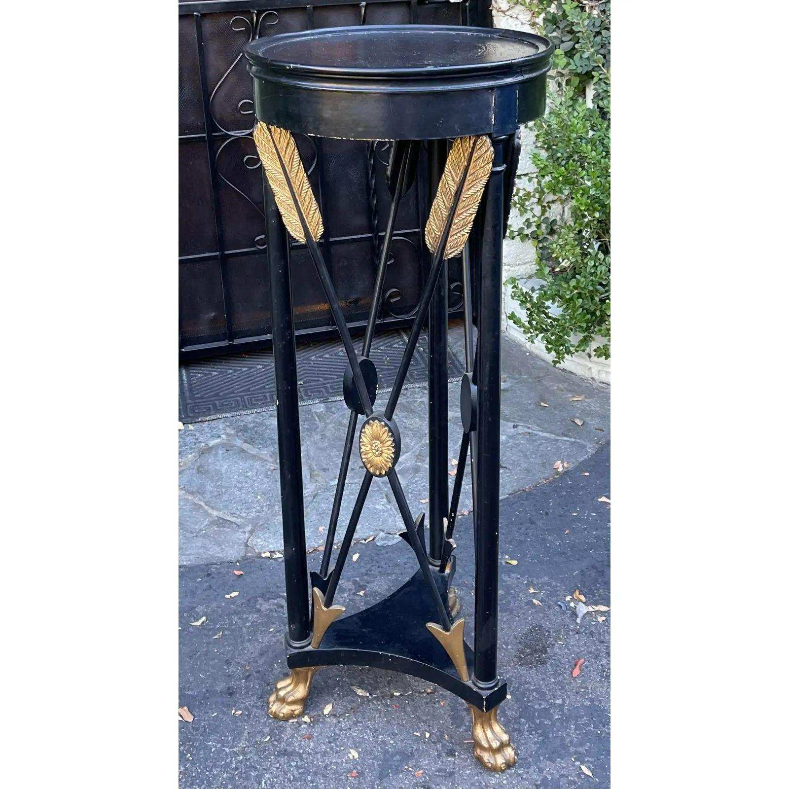Antique French Empire Style Black & Gold Giltwood Pedestal Plant Stand. It features a well worn paint decorated finish and giltwood details including paw feet and empire style crossed arrows.

Additional information: 
Materials: Giltwood
Color: