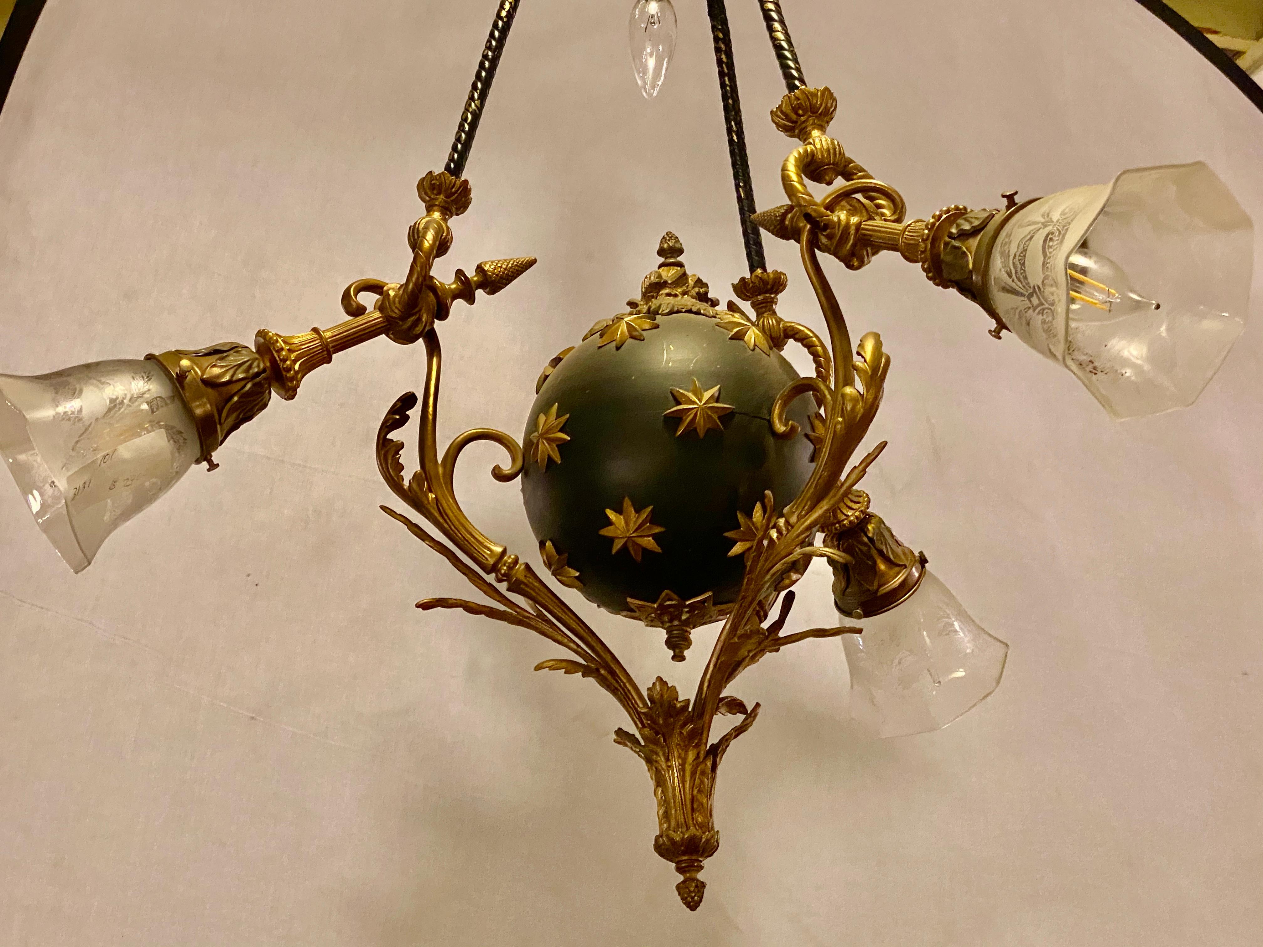 Antique French Empire style chandelier ebonized sphere with bronze surrounds. With four lights. Center etched glass shade missing. ON SALE
