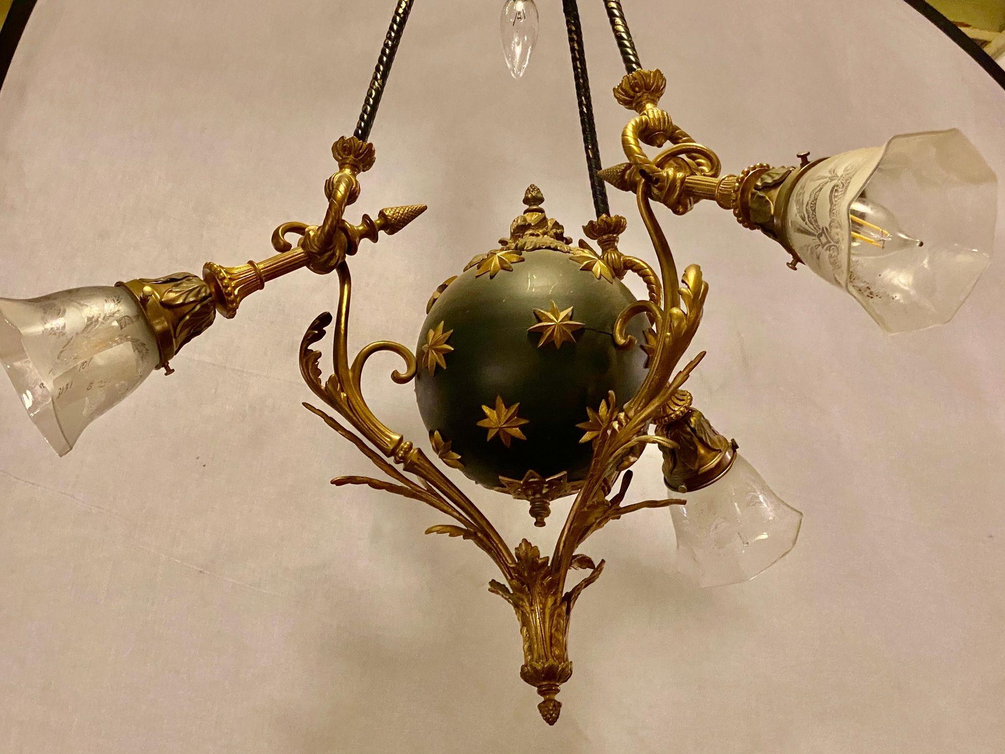 Antique French Empire style chandelier ebonized sphere with bronze surrounds. With four lights. Center etched glass shade missing.

