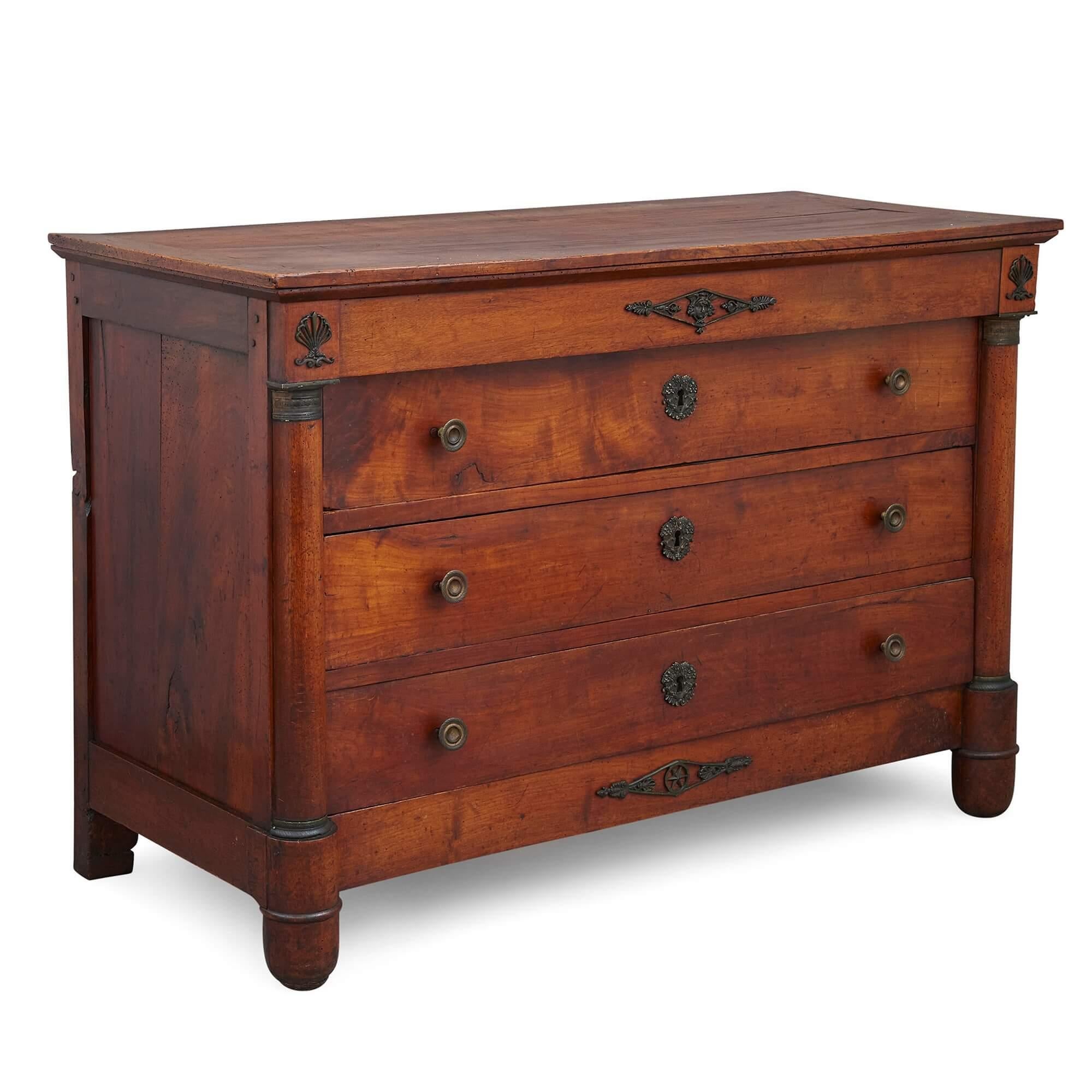 Antique French Empire style chest of drawers
French, 19th century
Measures: Height 86cm, width 127cm, depth 57cm

This beautiful chest of drawers was crafted in France in the 19th Century. It employs classical ornament sparingly and utilises the