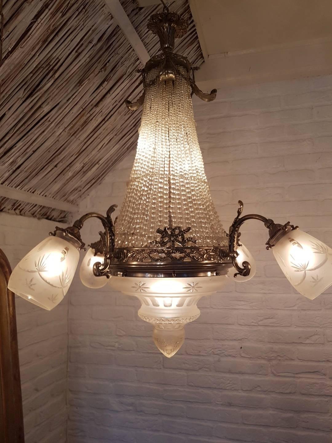 Antique sac de pearl chandelier. The top is made of a multitude of crystal beads and the bottom of the Chandelier is a large and beautiful coupe of Victorian cut frosted glass and four shades of Victorian cut frosted glass connected to the ring in