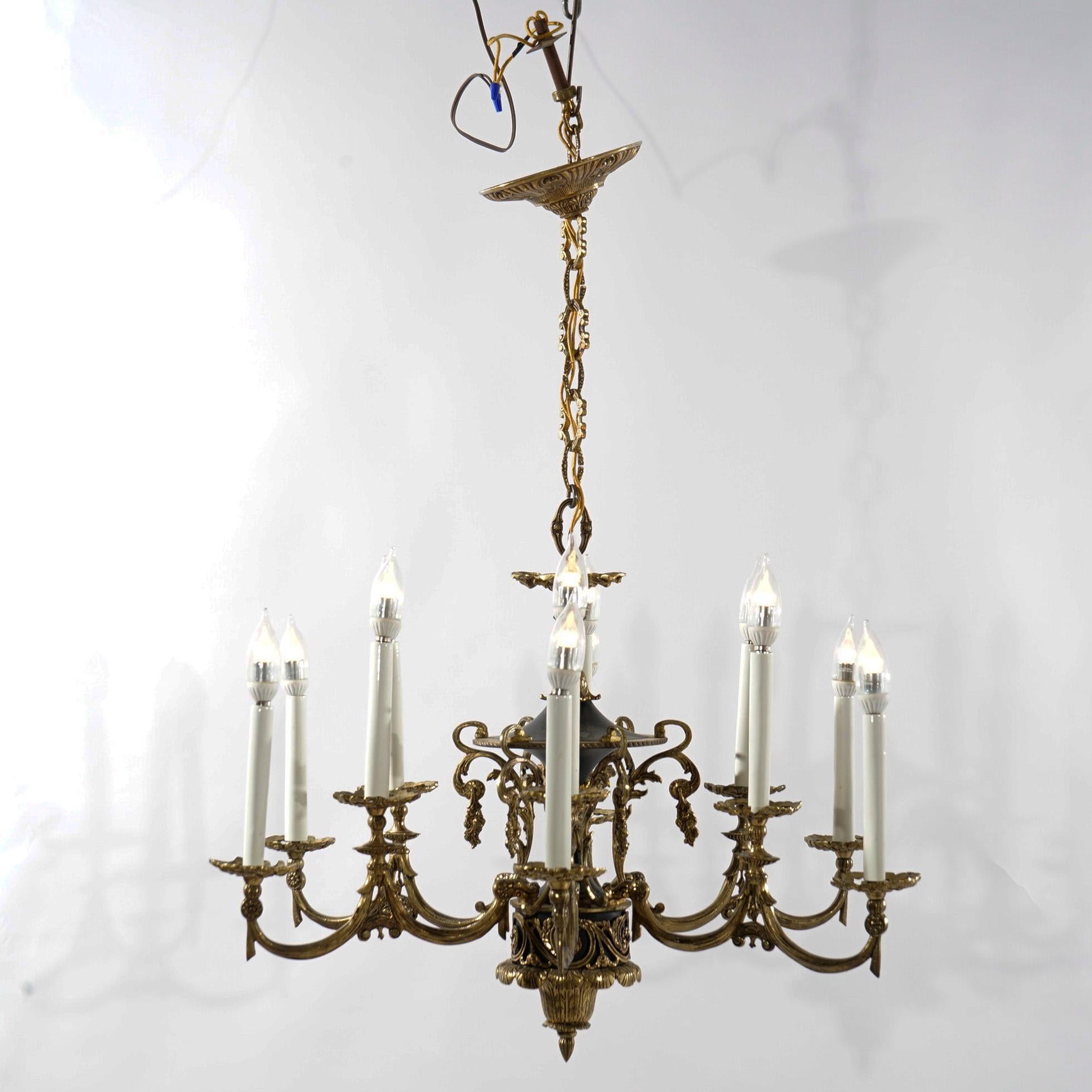 An antique Classical French Empire style chandelier offers cast bronze construction with ebonized bodice having twelve foliate form scroll arms terminating in candle lights, early 20th century

Measures- 34.5''H x 28''W x 28''D; 9'' drop

Catalogue