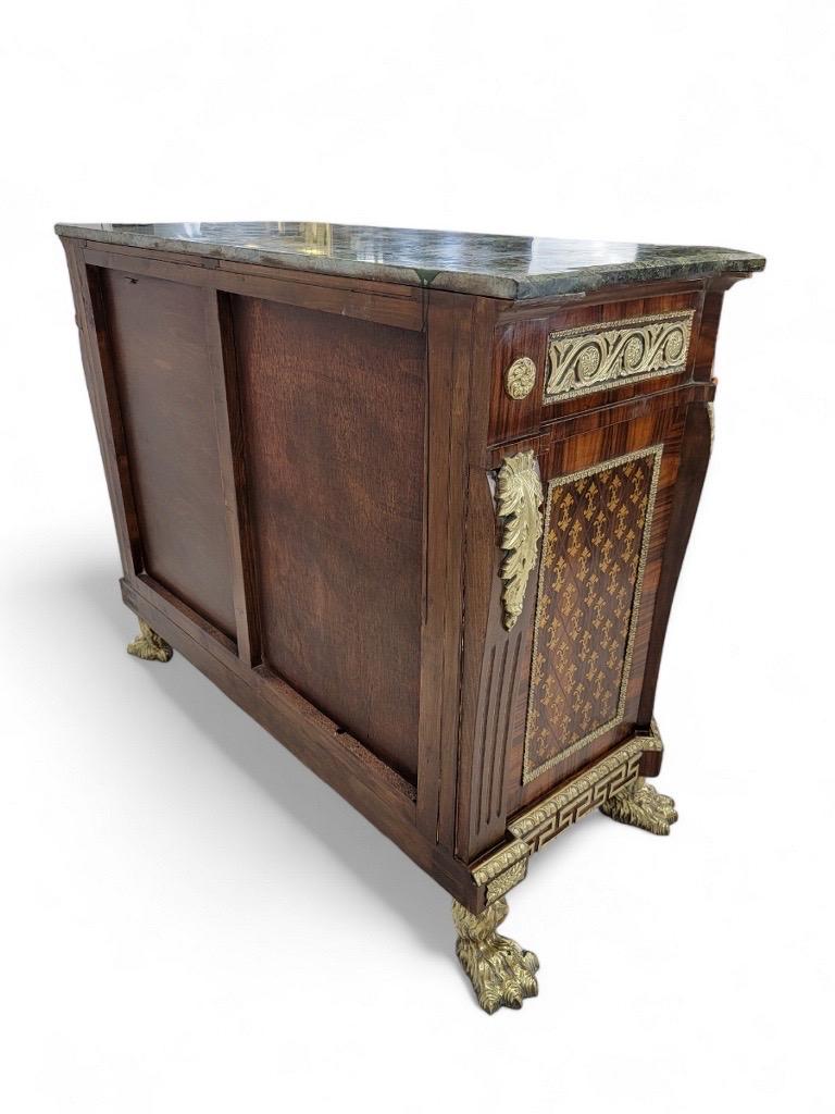 Antique French Empire Style Marquetry Inlay Commode Chest of Drawers

Gorgeous French Empire style commode/chest of drawers featuring intricate inlaid marquetry with a finely detailed inlaid ribbon dual torch focal point. The central design is