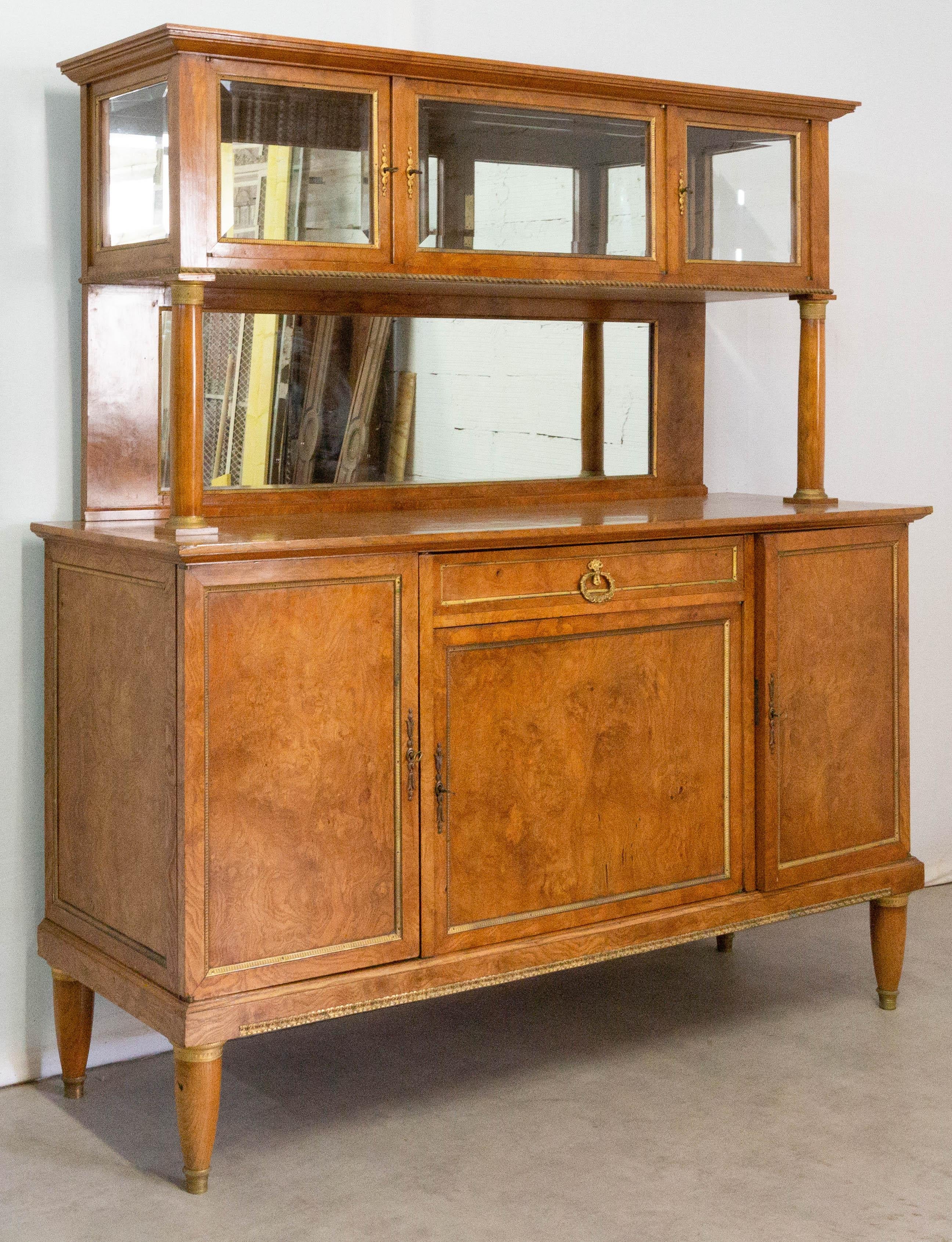 Empire style vitrine buffet antique, French, early 20th century
Burled elm wood and bronze
Beveled glass display cabinet.
Good antique condition with superb patina

Shipping:
2 packs: 
Pack 1: Top L165/ P 45.5/ H 85 cm
Pack 2: L 175/ P 45.5/ H 104