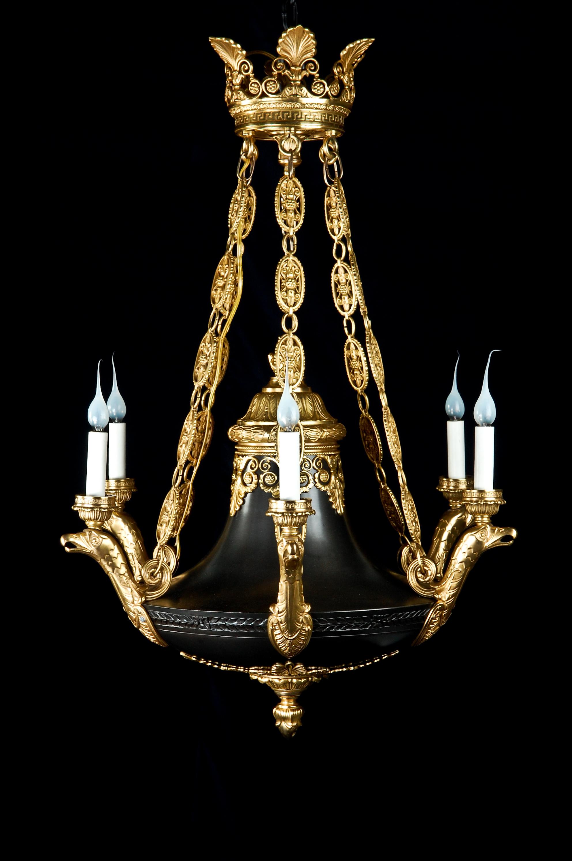 A superb and unique antique French Empire style neoclassical gilt and patinated bronze multi light chandelier of fine detail. This fine chandelier is embellished with reticulated gilt bronze chains, neoclassical gilt bronze ornaments and further