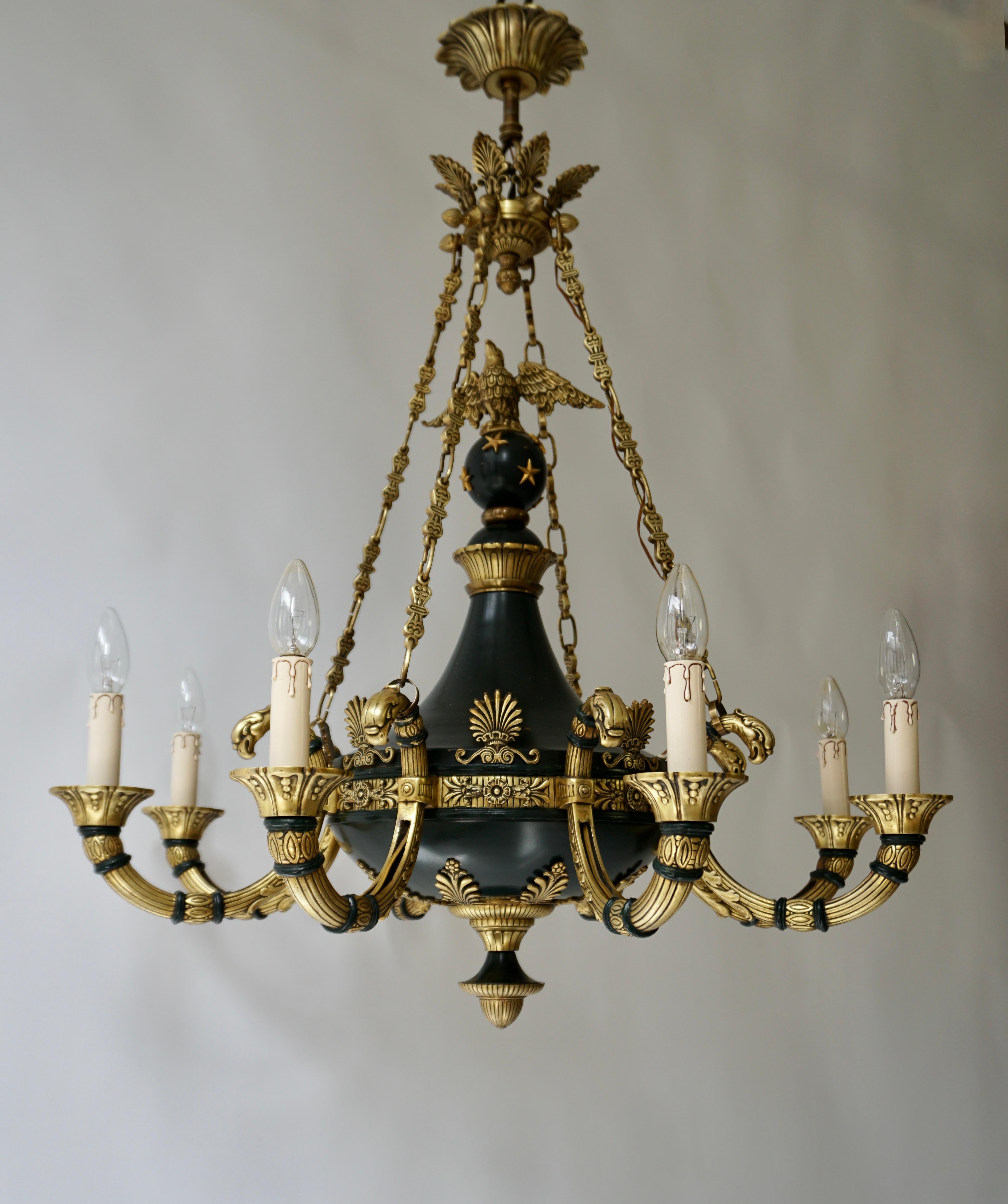 A handsome and high quality French 19th century Empire style patinated bronze gilt chandelier.

A superb and unique antique French Empire style neoclassical gilt and patinated bronze multi light chandelier of fine detail.This fine chandelier is