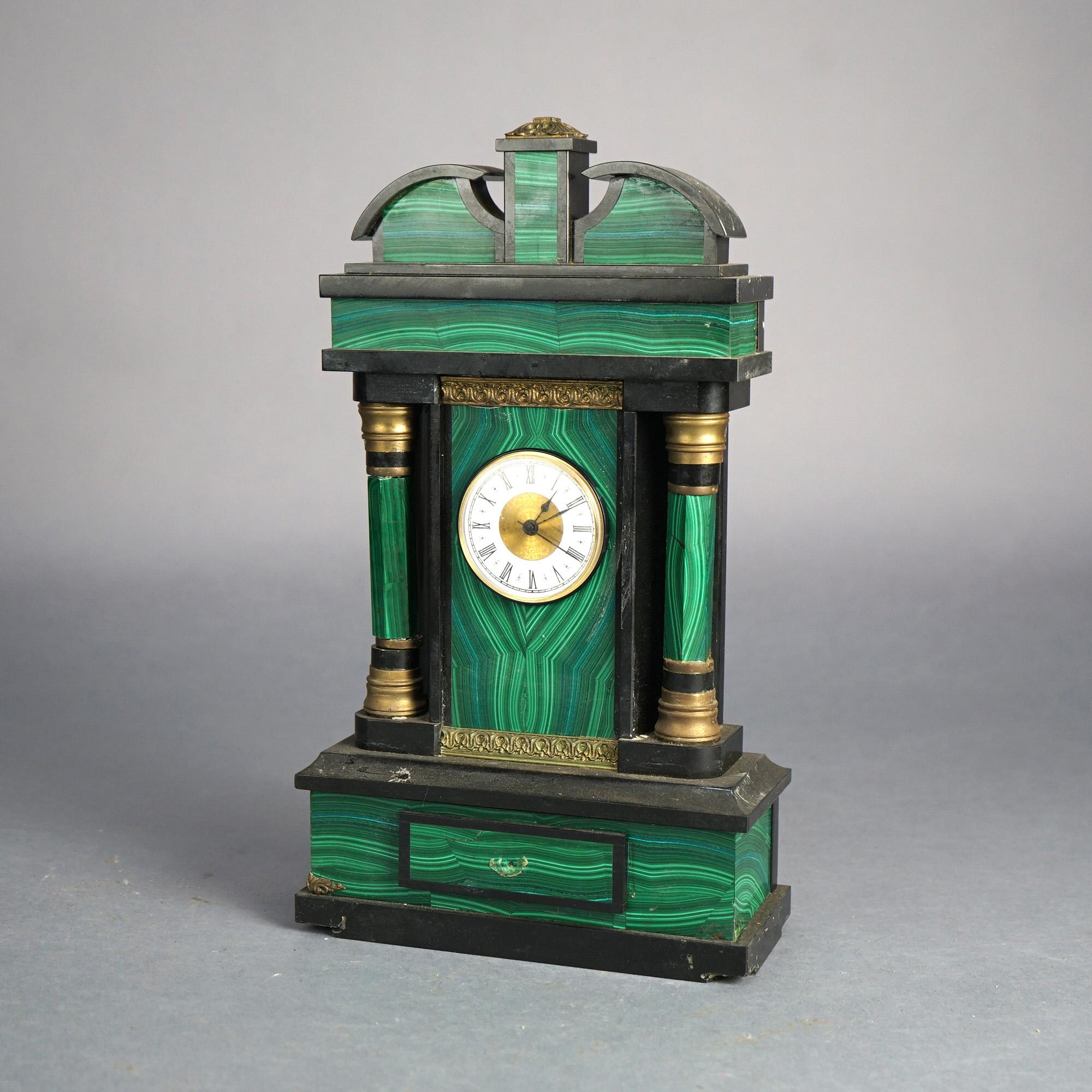 Antique French Empire Style Slate and Malachite Clock with Broken Arch Crest and Doric Columns, 19thC

Measures- 14.5''H x 8.25''W x 3.5''D