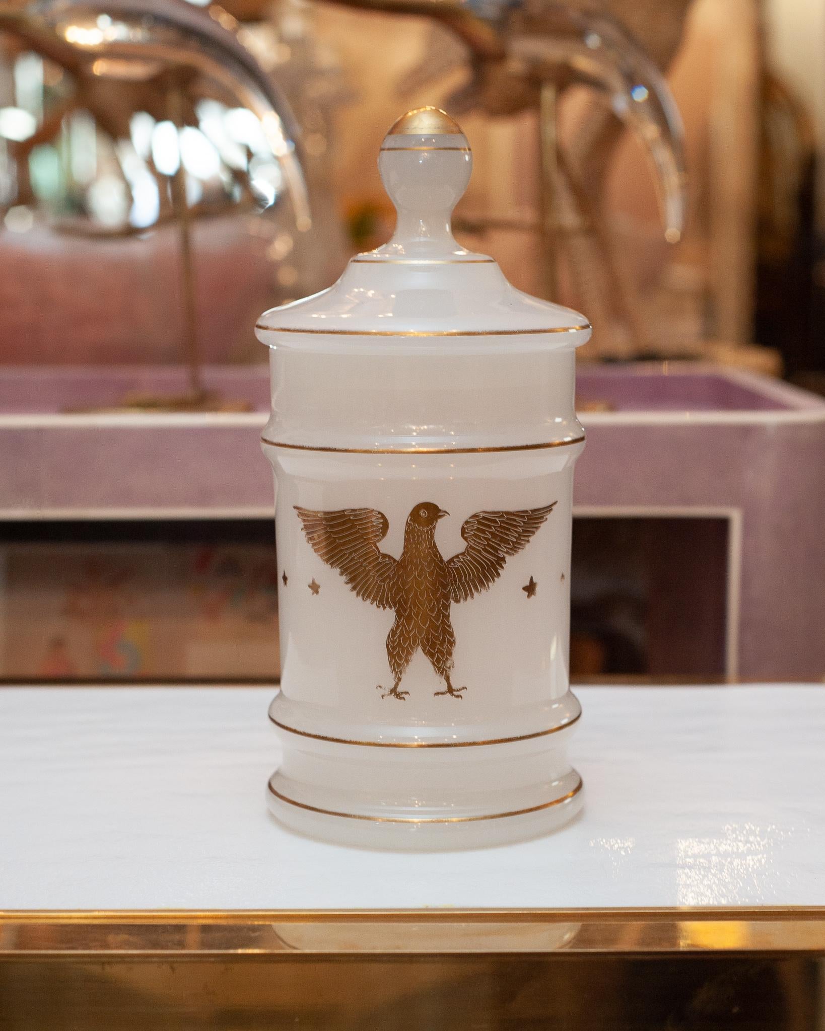 A well preserved and unique French opaline glass jar from the Empire period. Opaline glass was made in France between the years of 1810-1890. This Empire opaline jar with lid has a gold leafed eagle motif and would be appropriate in a bathroom to