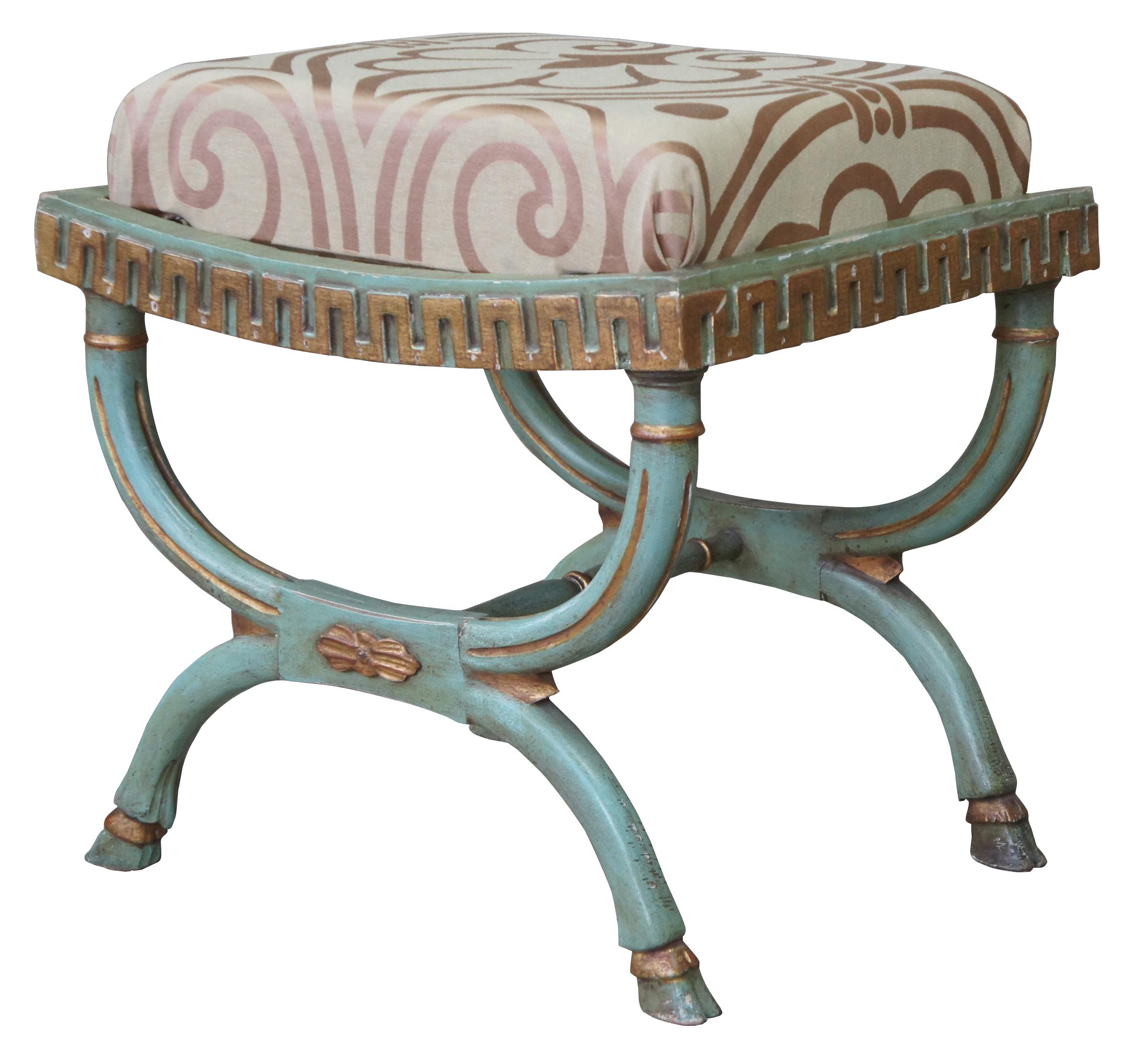 Early 20th century antique French Empire style foot stool or bench. A Bohemian green featuring the classical French X form with gold fluting and hoof feet. Upholstered with a fleur de lis fabric. Measures: 21”.
  