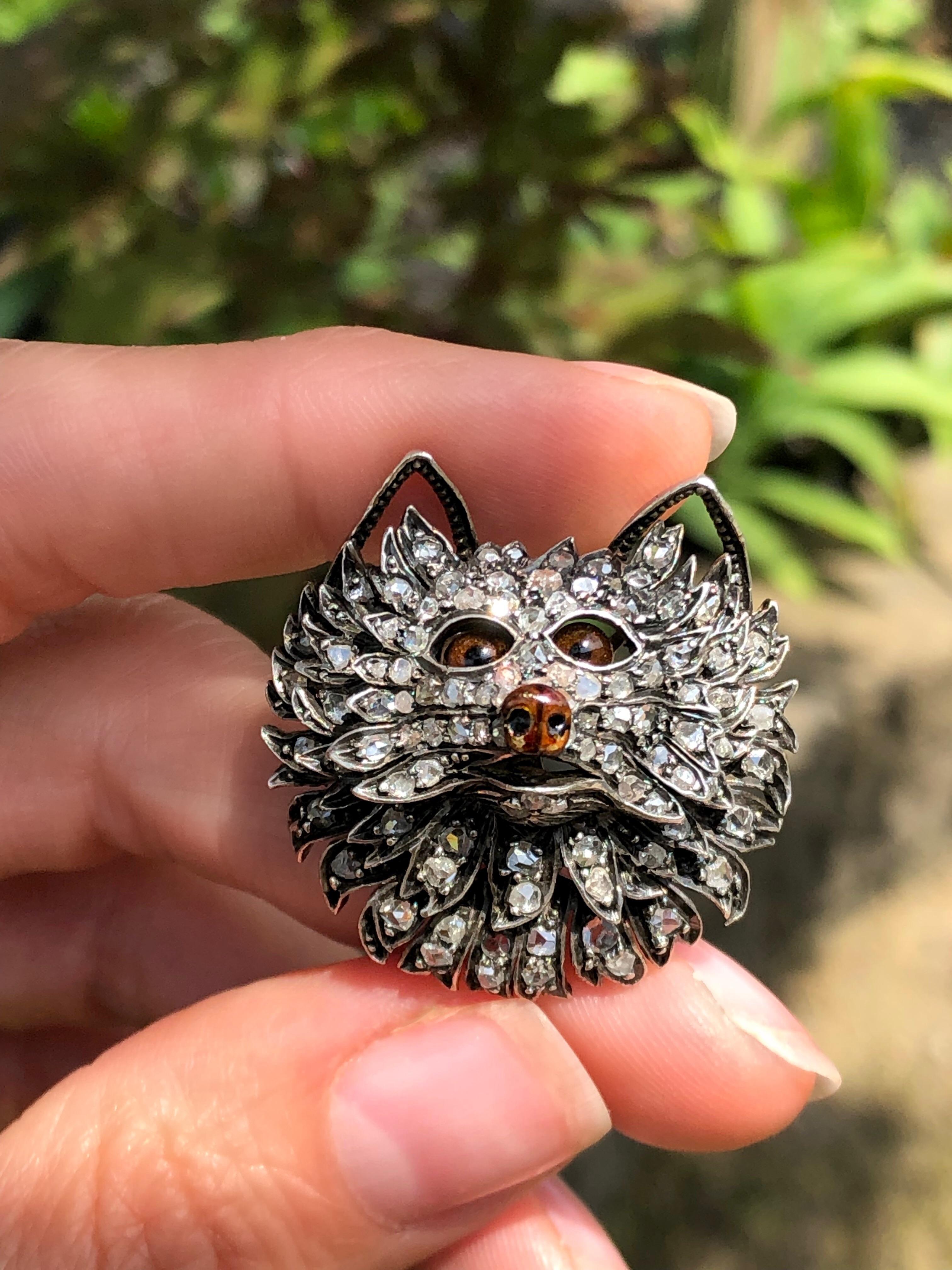 This adorably scruffy pup dates to late 19th century, France. Masterfully hand fabricated in silver topped 18k rose gold, tiny brown glass eyes almost to come to life next to the shimmer from the rose-cut diamonds. Complete with a glossy brown