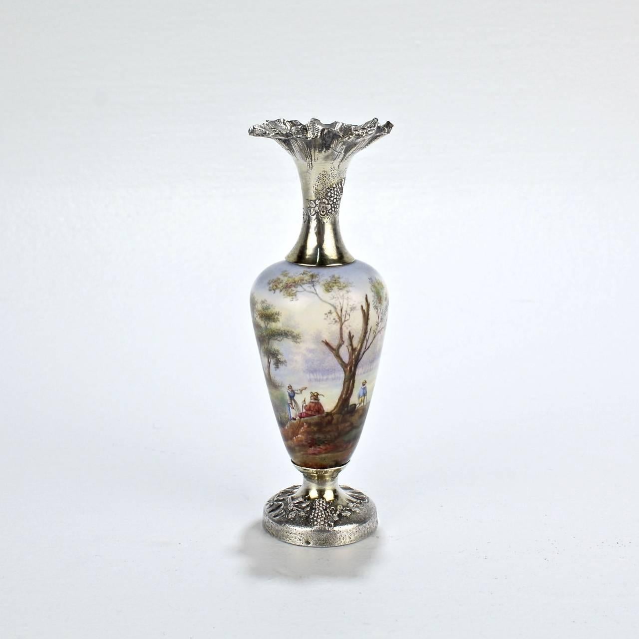 A fine and rare French sterling silver and enamel cabinet vase.

The enameled central body depicts a bucolic French country landscape with a watermill and river. 

The ruffled silver top and foot both appear to retain traces of a gold wash. Each