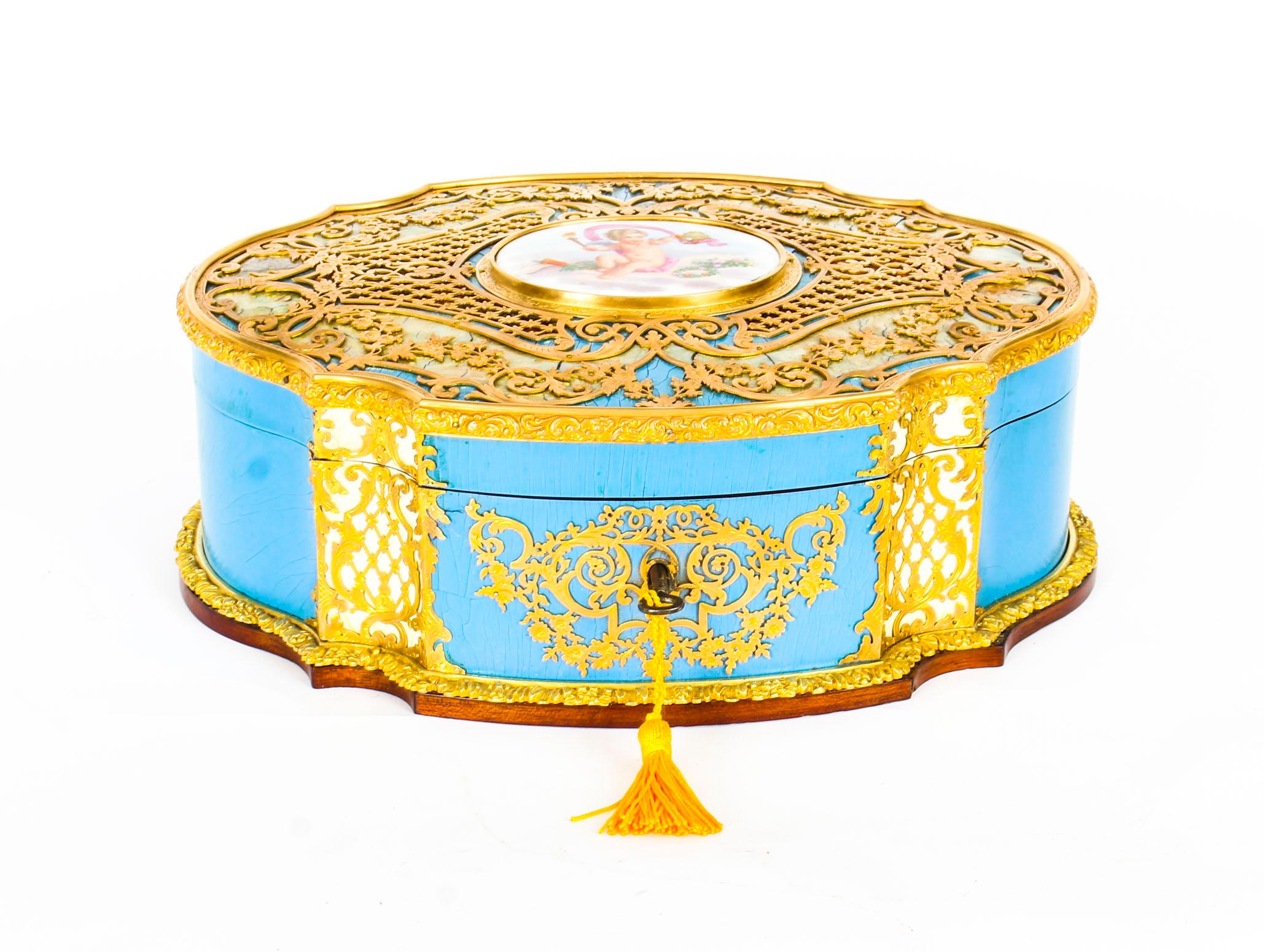 This is a magnificent antique French enamel, ormolu and mother of pearl casket fitted with a beautiful hand painted Sèvres Porcelain plaque of Cupid, later converted to a charming sewing box, dating from the 19th century.
 
This superb large
