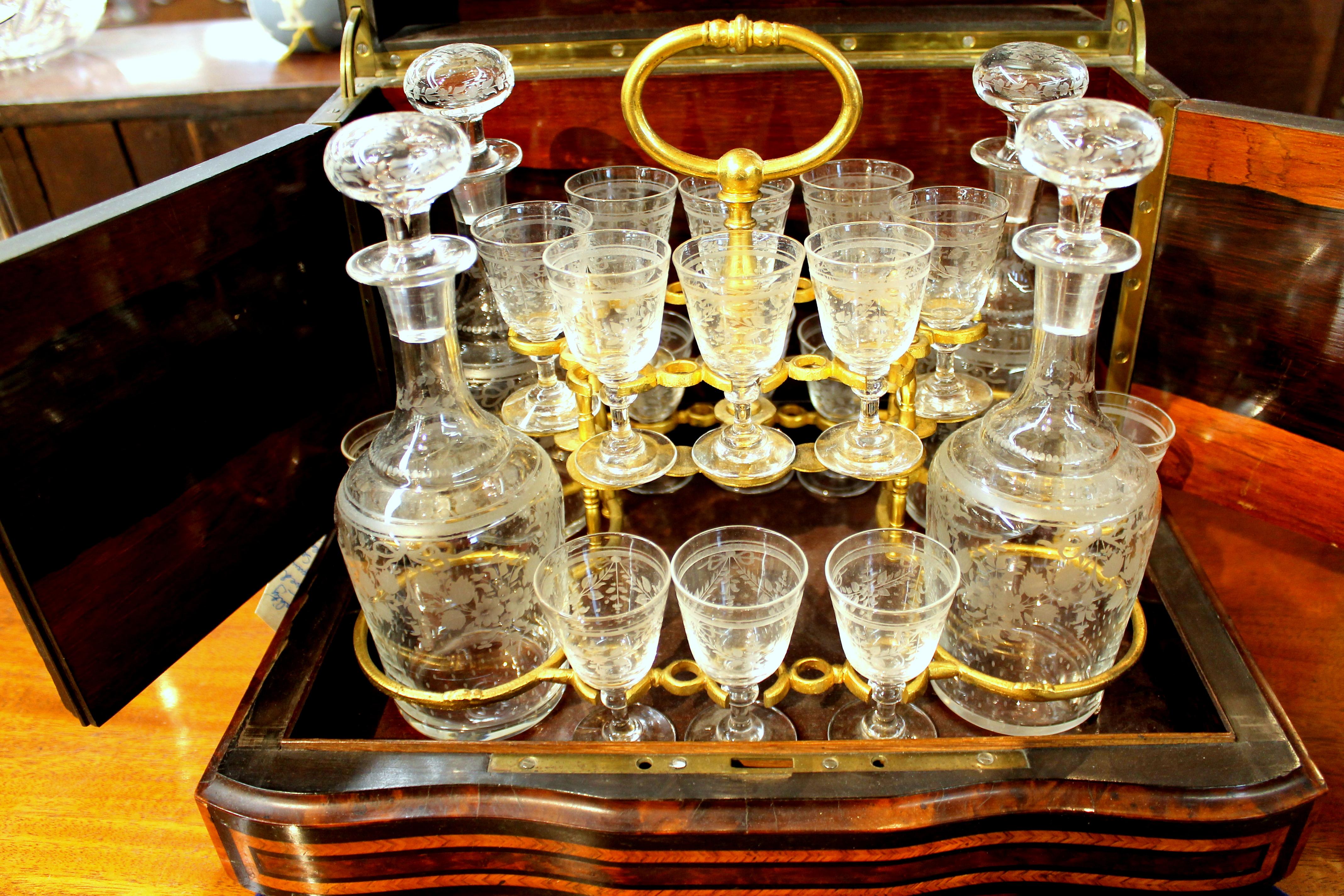 Extraordinary quality antique French 24-piece hand engraved crystal cave a' liqueur (Cordial or Liqueur) Tantalus set with magnificent inlaid amboyna wood and kingwood inlaid hinged case.
This is extremely rare in that the exquisite hand engraved