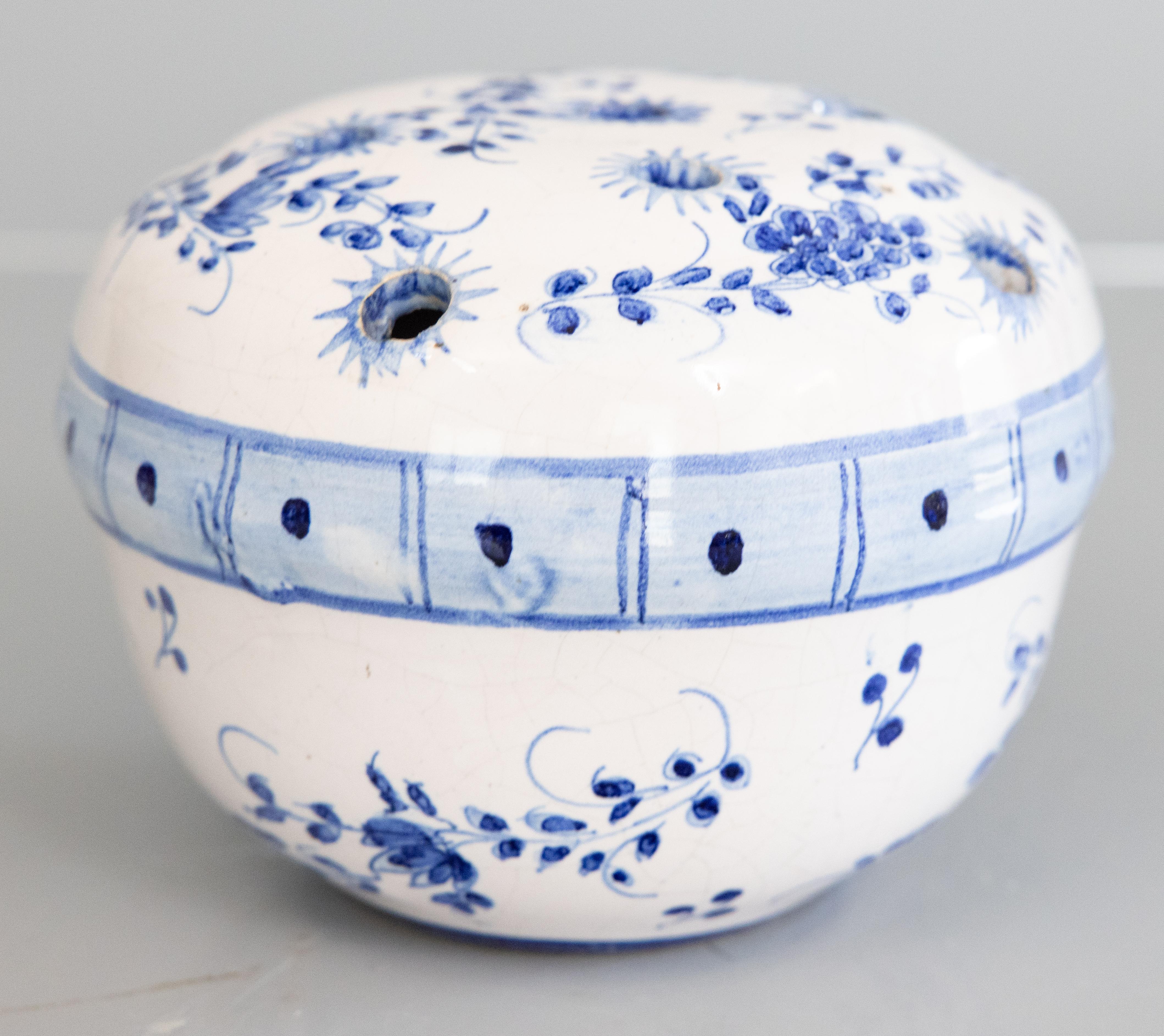 A fine antique French faience hand molded flower frog vase or rose bowl, circa 1900. This charming flower frog has a hand painted floral design in vibrant cobalt blue and white. It displays beautifully and would be lovely with your favorite