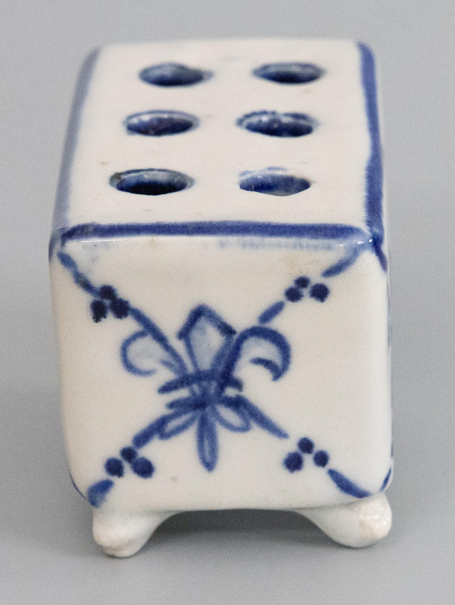 A fine antique early 20th-century French faience hand molded flower brick or flower frog vase. This charming footed flower pot has a hand painted fleur-de-lis design in vibrant cobalt blue and white. It would be lovely with your favorite flowers or