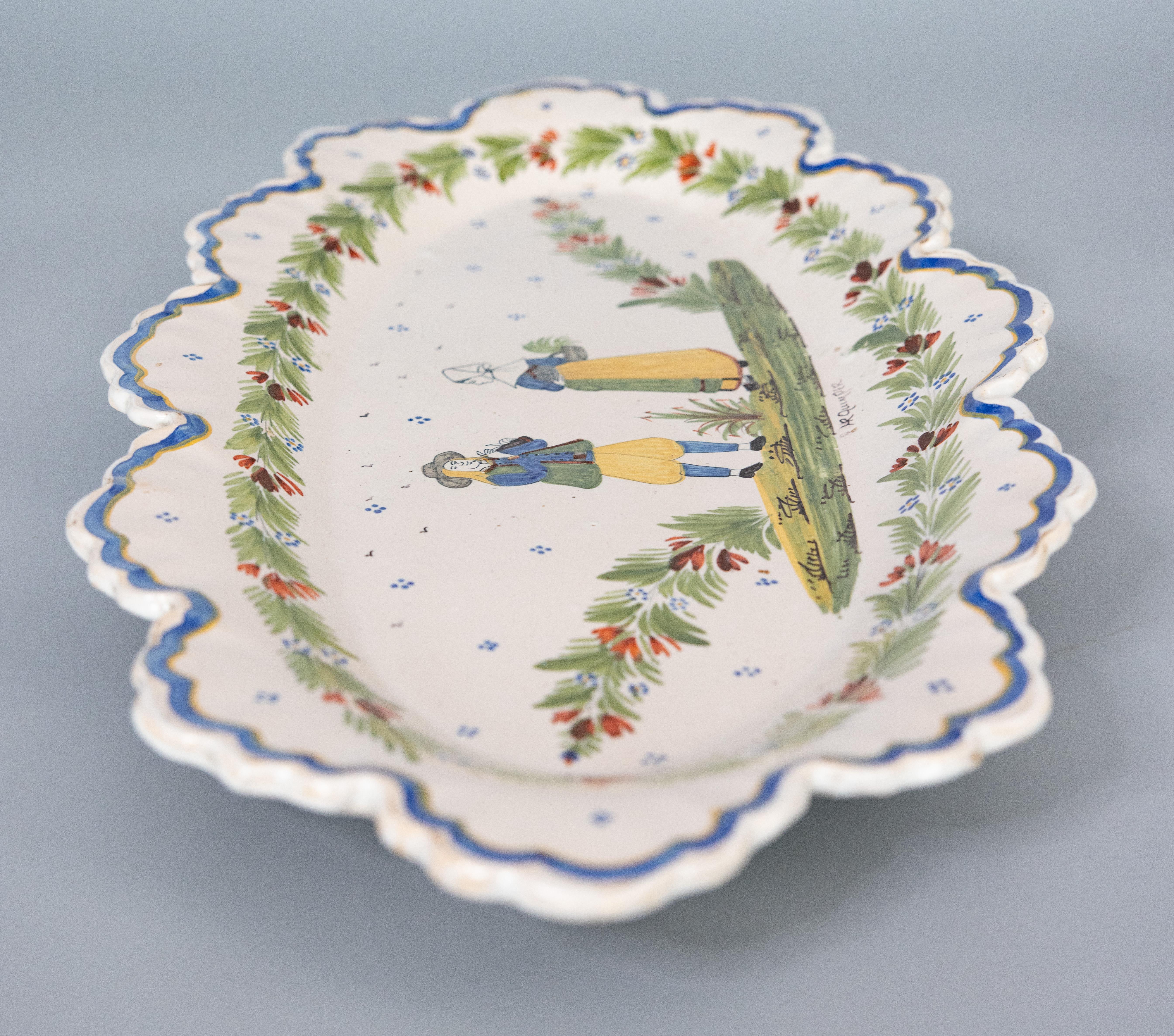 A superb large antique French provincial faience Quimper oval wall platter or charger, circa 1900. Marked 