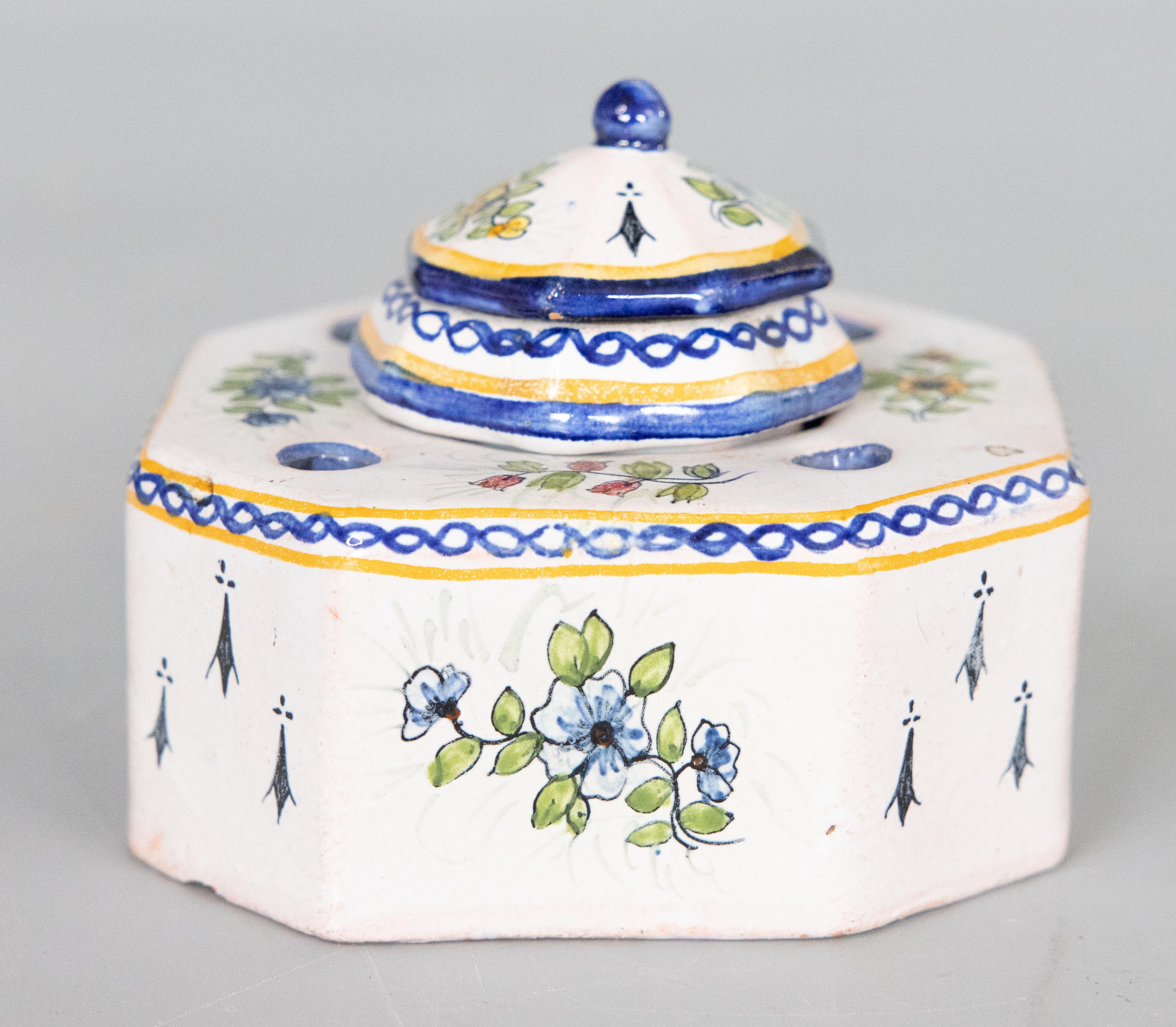 A charming antique French provincial faience Quimper style inkwell from the French province of Saint-Quay-Portrieux, circa 1900. Signed on reverse. This gorgeous inkwell is hand painted with a traditional Breton man surrounded by ermine tails and