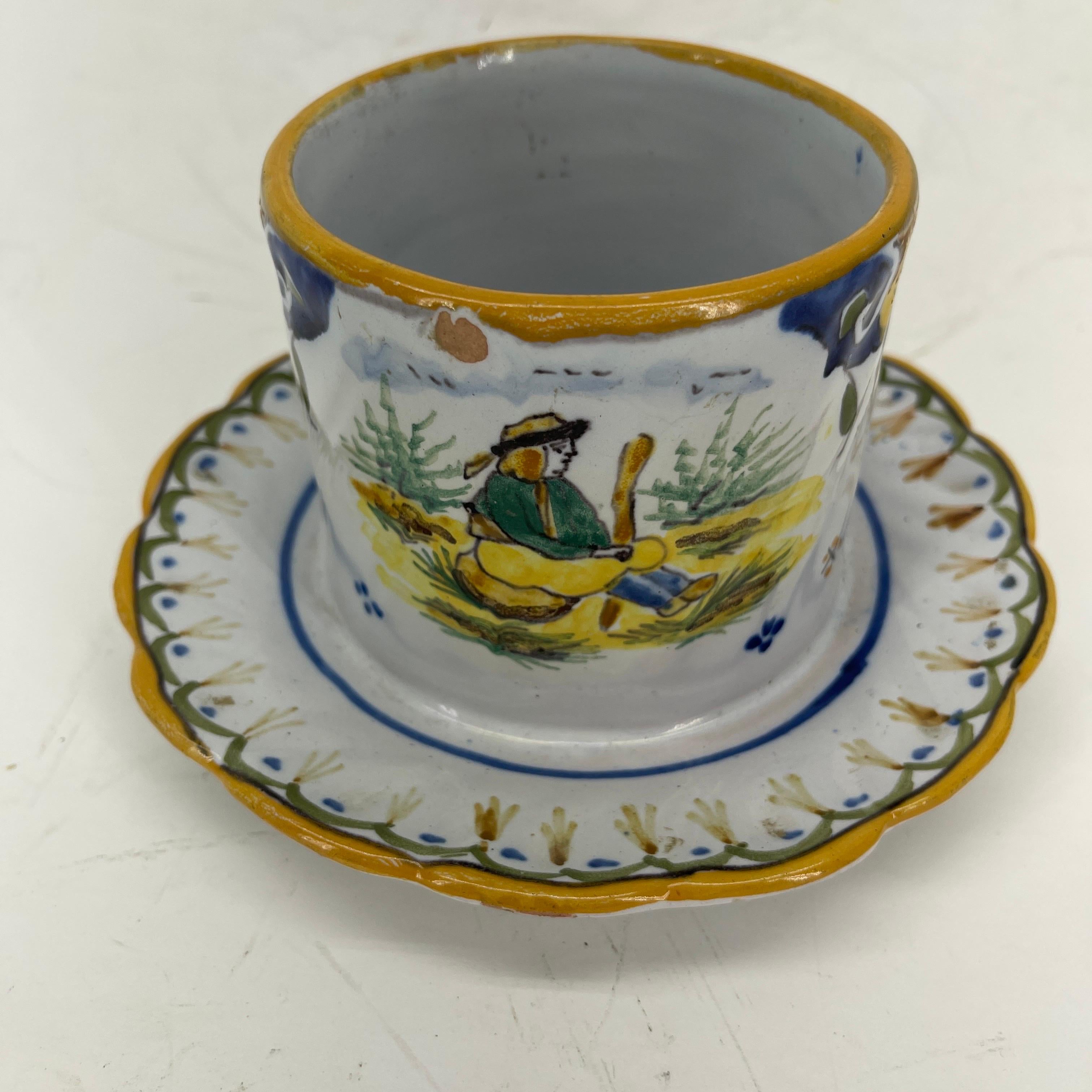 Polychrome Faience Wine Bottle Holder or Coaster, early 20th century France

An amazing and rare wine bottle coaster with blue, yellow and green decoration of a French man sitting. This hand painted piece was purchased many years ago on a buying