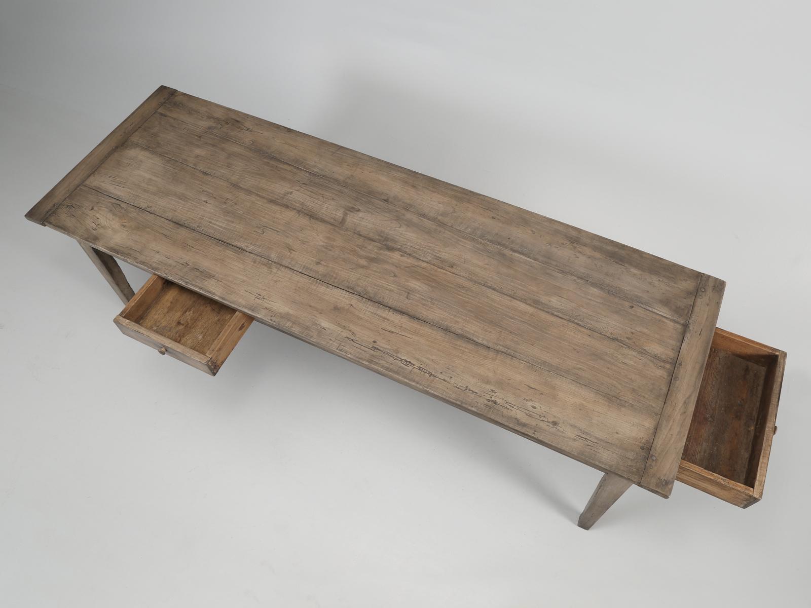 Antique French farm table from the south of France in the town of Marseille, with the preferred tapered legs and one small side drawer and one huge drawer at the end. The table has been rebuilt structurally in our Old Plank workshop as have both