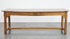 Antique French farmhouse dining table made of fruitwood from 18th century