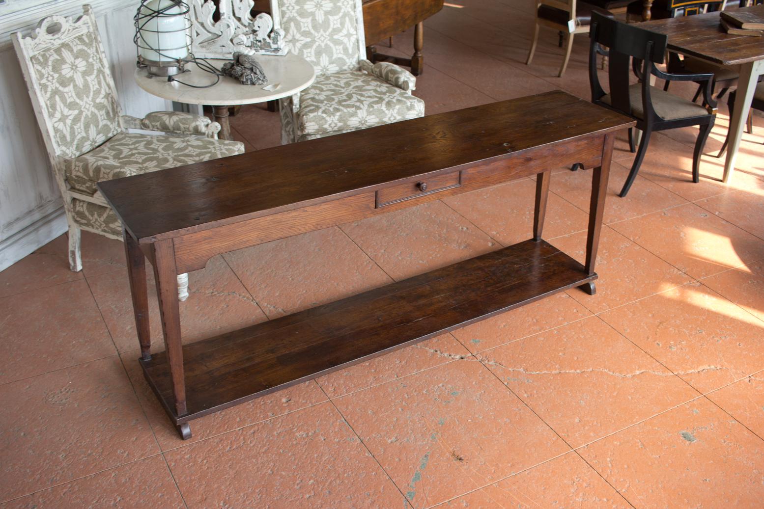 Antique Burgundian oak farmhouse work table or server or console with a single drawer and shelf below sitting on pencil shaped legs. Lovely rich patina.