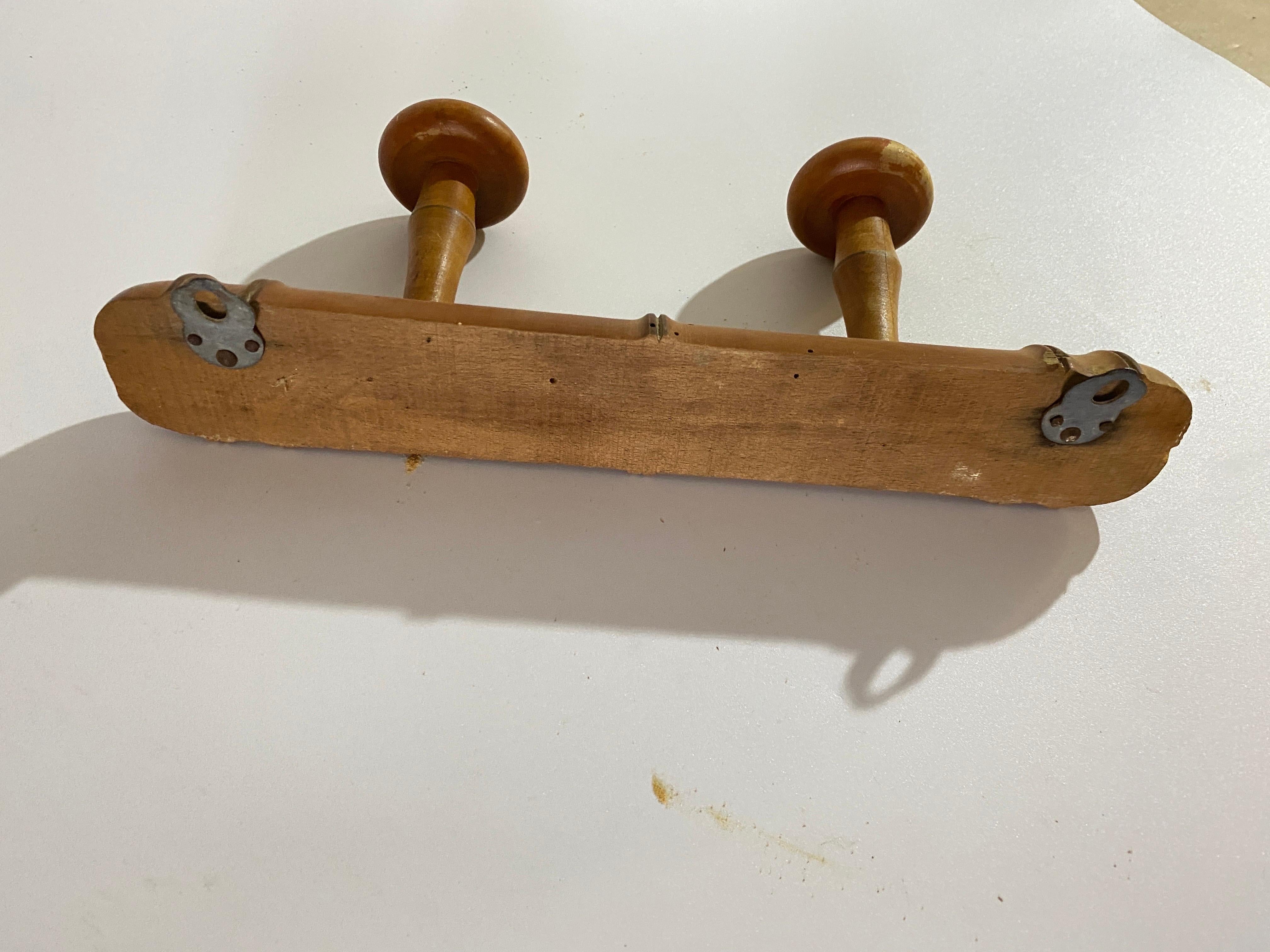 A superb antique French faux bamboo carved wood coat rack, circa 1920. This fine rack retains the lovely original surface and patina and has four hand turned pegs, perfect for hanging jackets and hats in an entryway or mudroom.