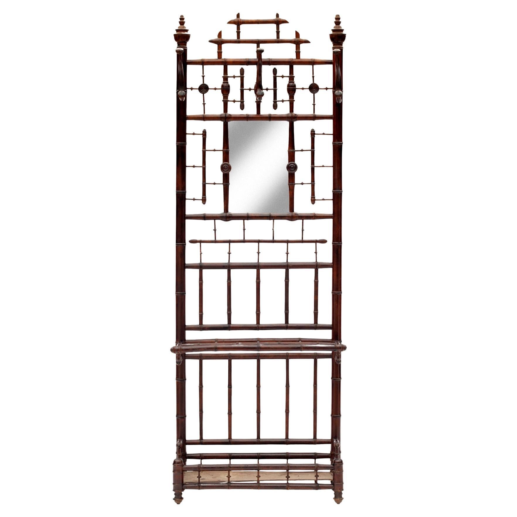 A superb French faux bamboo hallstand in hardwood.
Original bentwood hooks & hand turned knobs & umbrella drib tray.
Small mirror in the center. New mirror.\ed glass.
Made to accommodate coats hats & umbrellas with 3 large bentwood hooks & four