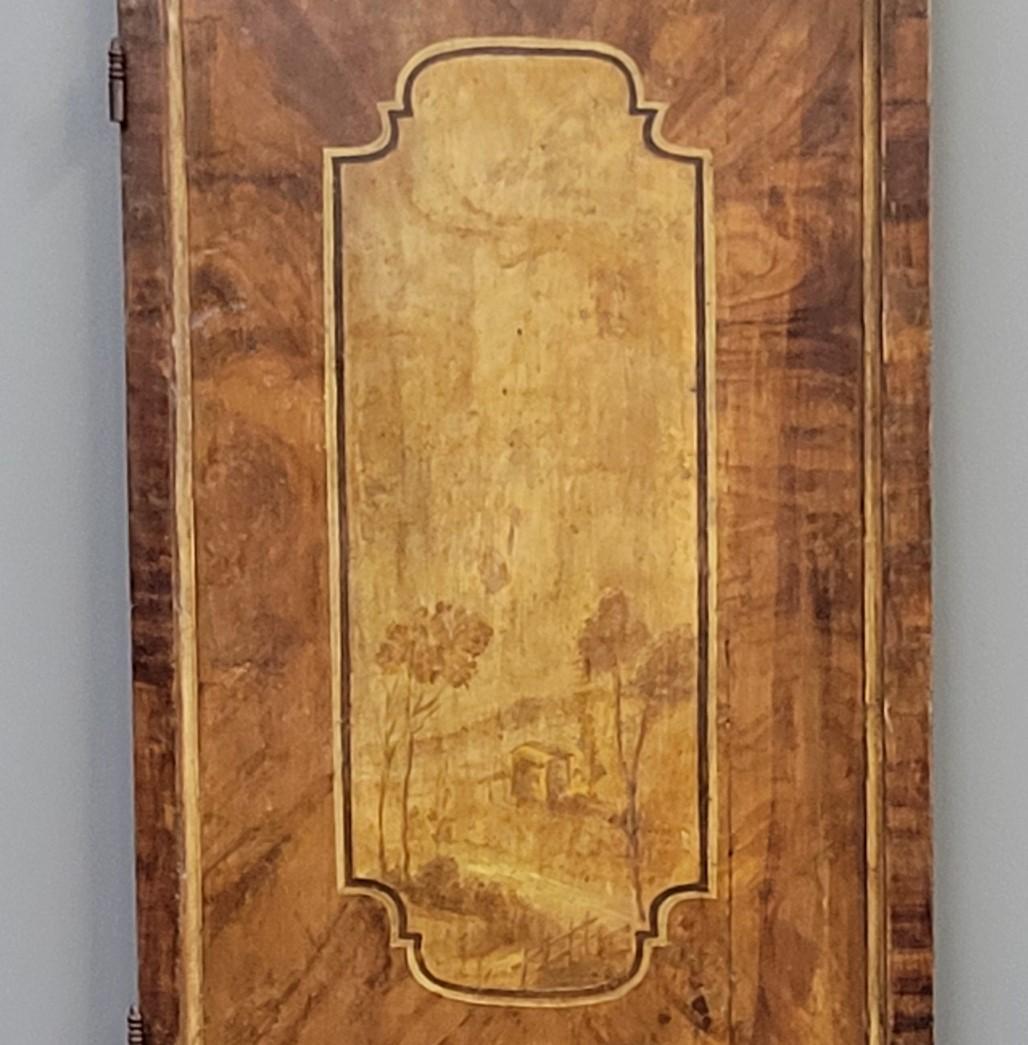 A gorgeous turn of the century French armoire or cupboard door with original grain paint to replicated wood grain. Top and bottom medallions frame beautifully painted landscape scenes. A stunning piece that could be built into a house as a pantry