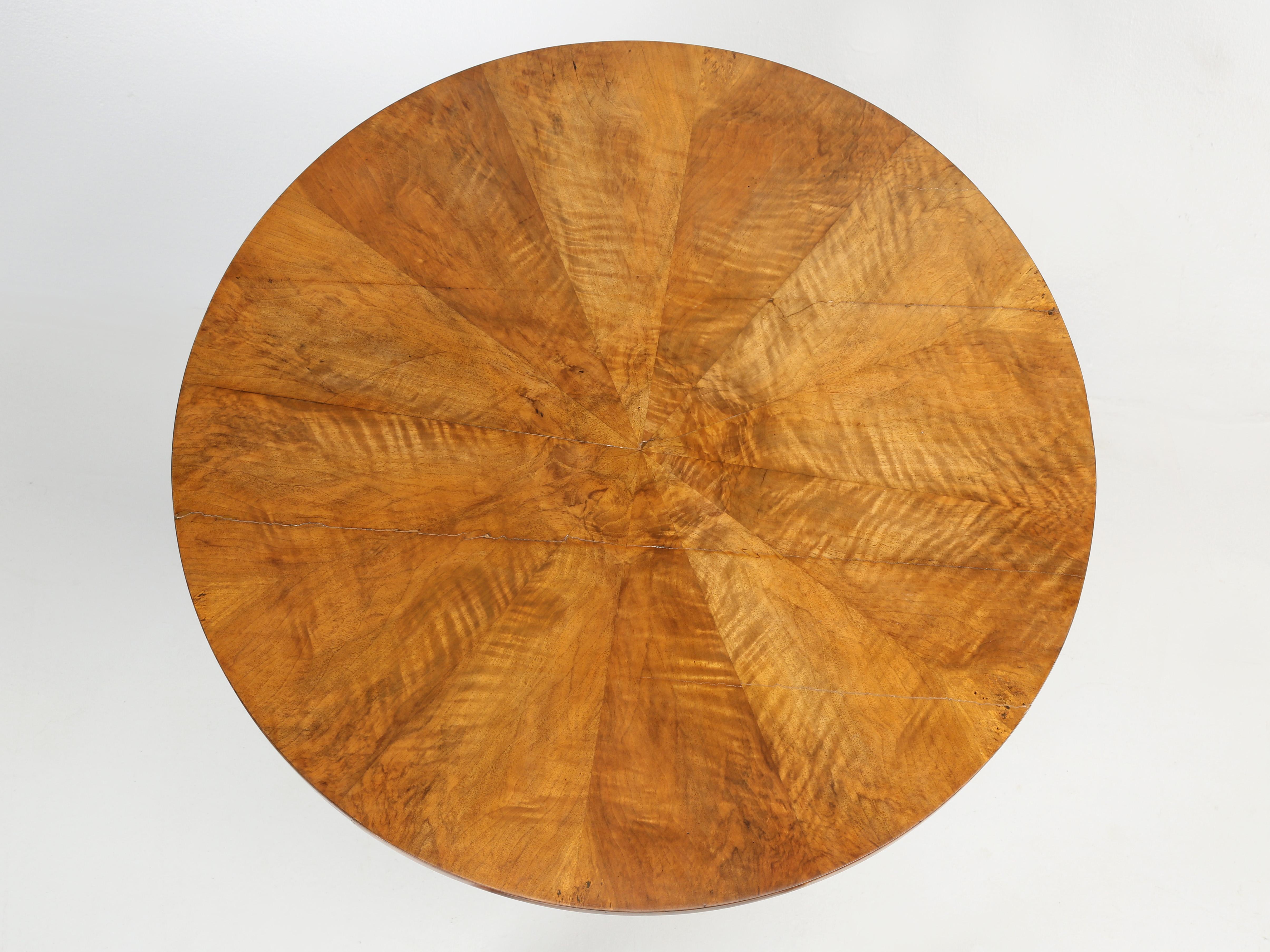 Antique French Center Hall Round Table in the style of Louis Philippe, crafted from beautiful figured French walnut in a classic sunburst pattern, with lion paw feet. We received our French round center hall table pretty much in the condition you