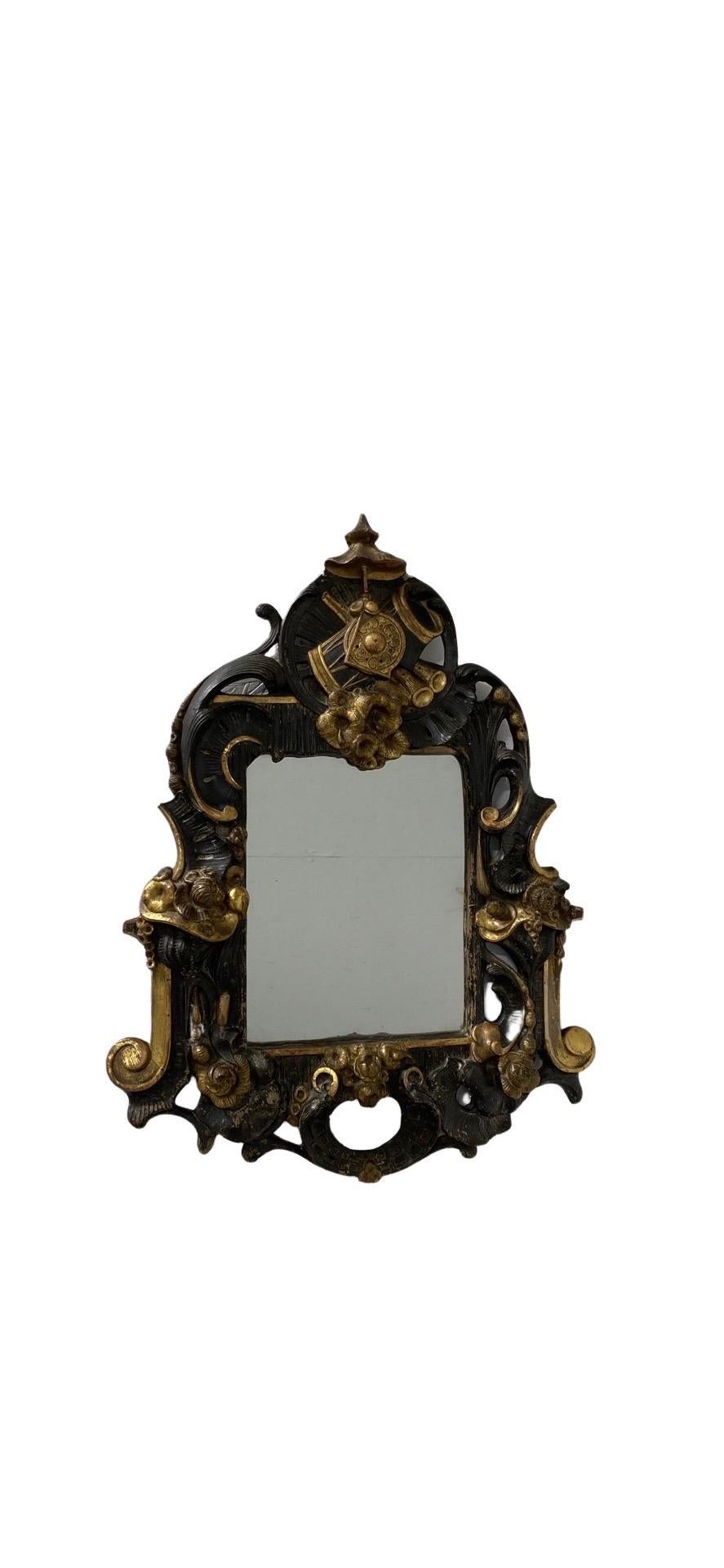 Antique French finely carved gilt and carved wood musical wall mirror Circa 1830.
Mirror features and ebonized body, gilt detailing, pierced frame and a wonderful carved musical instrument form cartouche to the top.