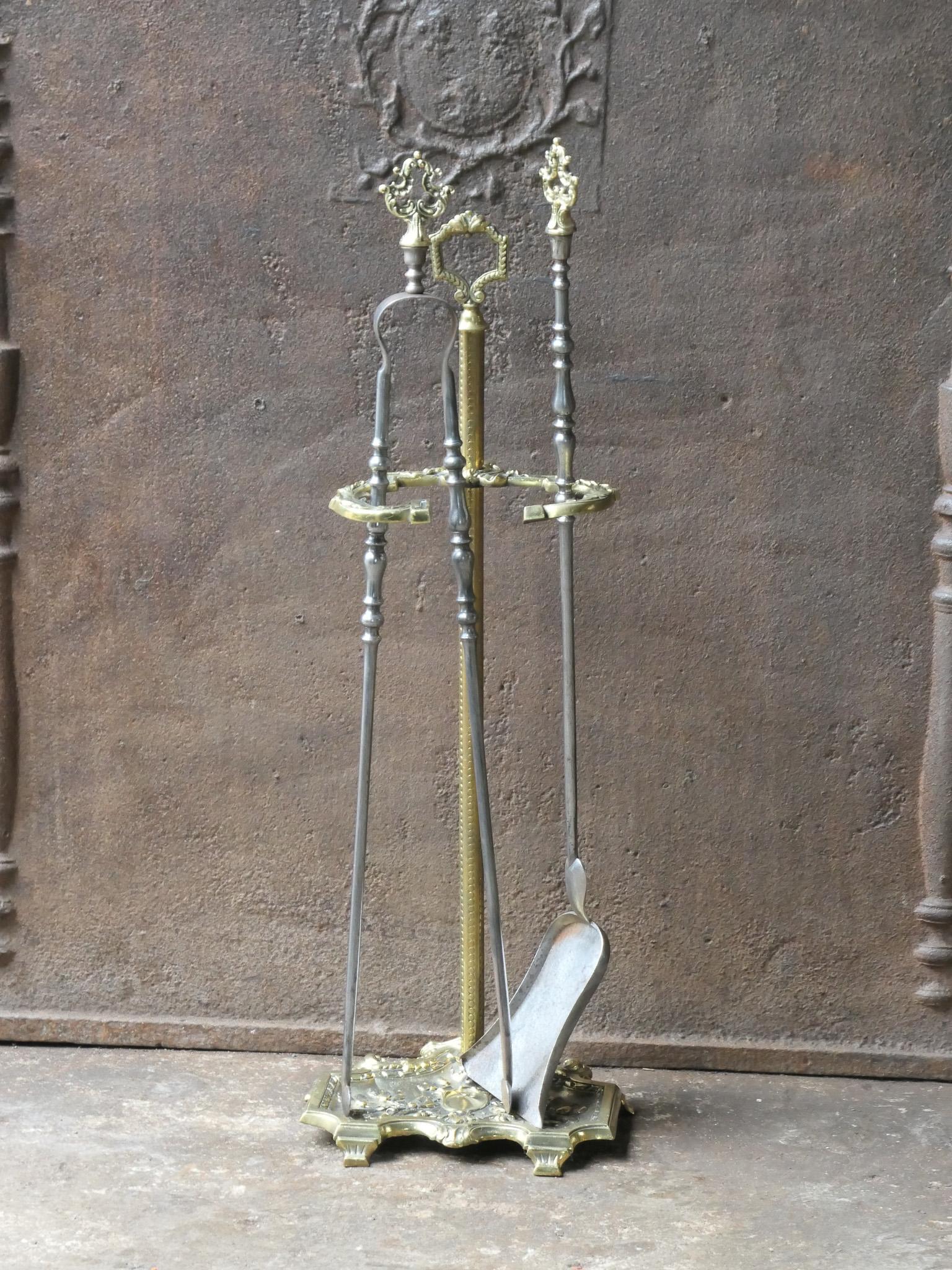 Late 19th or early 20th century French Napoleon III fireplace tool set. The toolset consists of a stand and two fire irons. Made of wrought iron and brass. It is in a good condition and is fully functional.
 
 





 