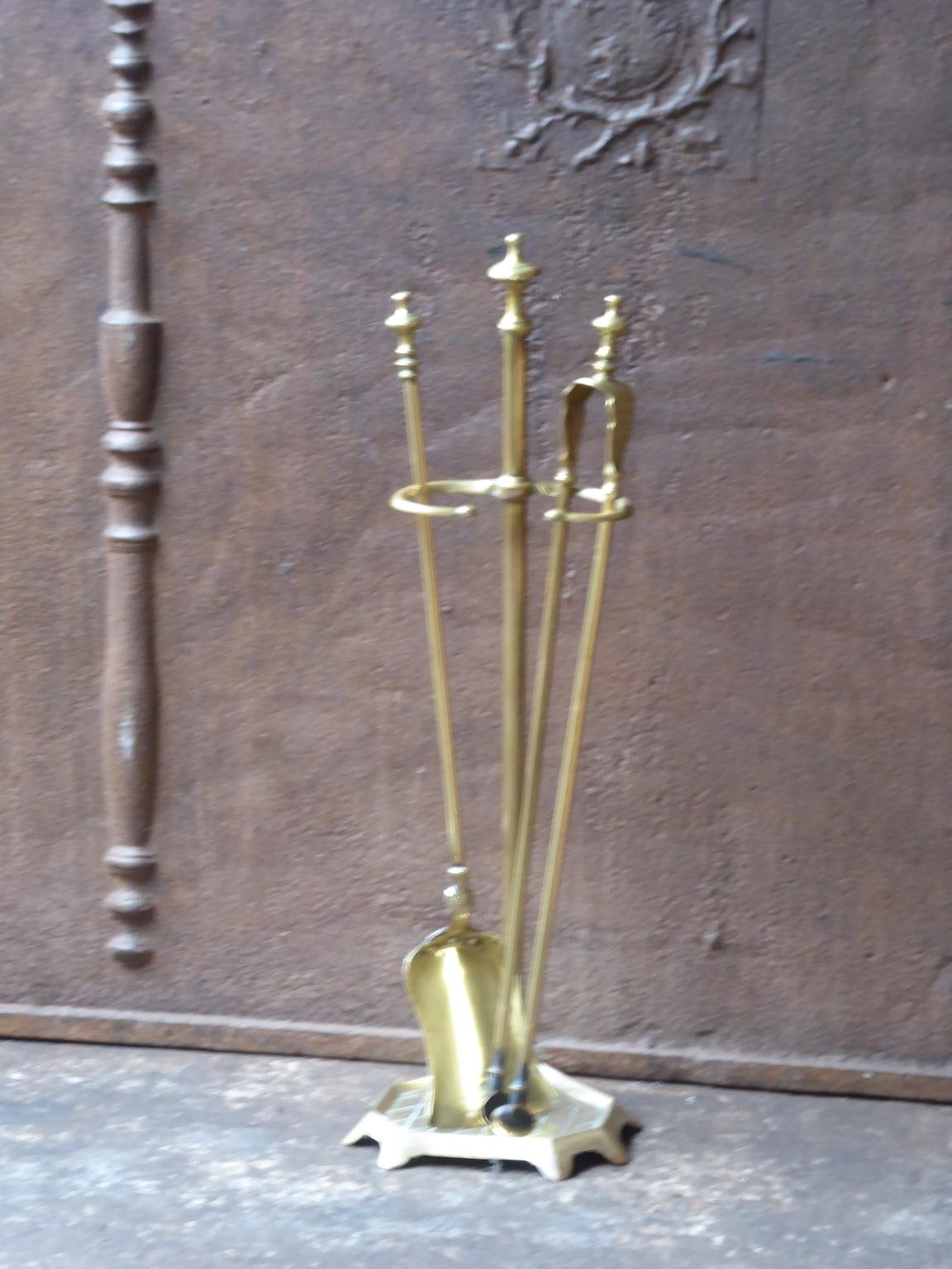 19th-early 20th century French Napoleon III fireplace tool set, fire irons made of polished brass. The toolset consists of a stand and two fire irons. It is in a good condition and is fully functional.







 