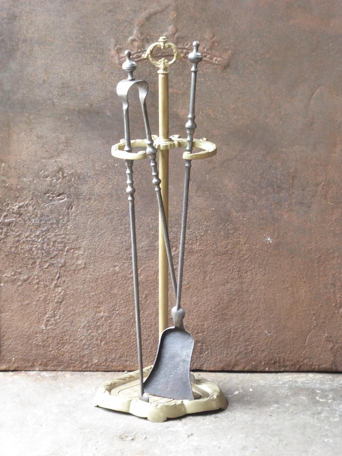 19th-early 20th century French Napoleon III fireplace tool set, fire irons. Made of wrought iron and brass. The toolset consists of a stand and two fire irons. It is in a good condition and is fully functional.







 