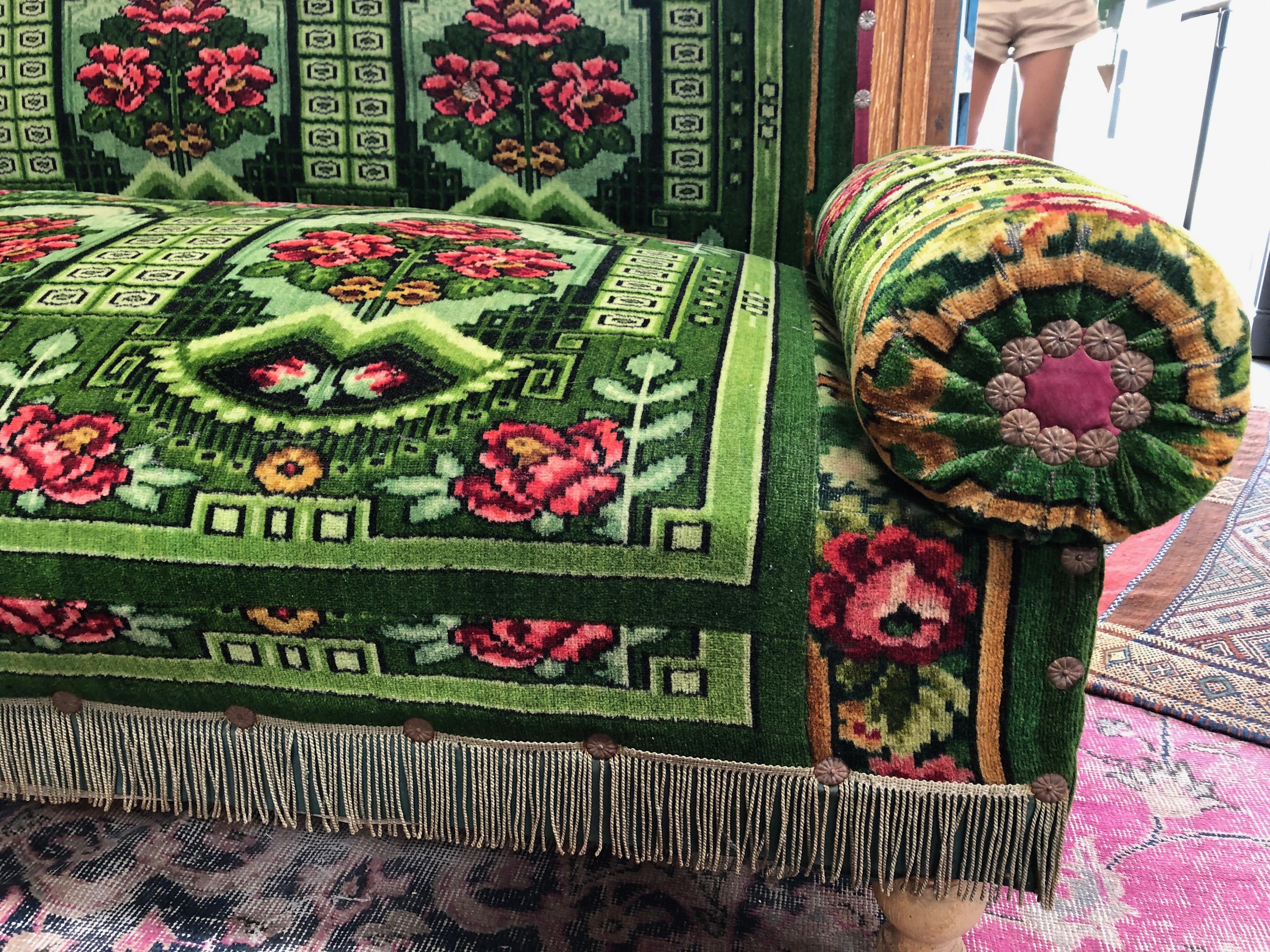 This antique French floral settee is upholstered with a vibrant green fabric featuring a floral pattern and embellishments, adding elegance and classic beauty to any home. Arms and backing are both removable which makes storing and rearranging